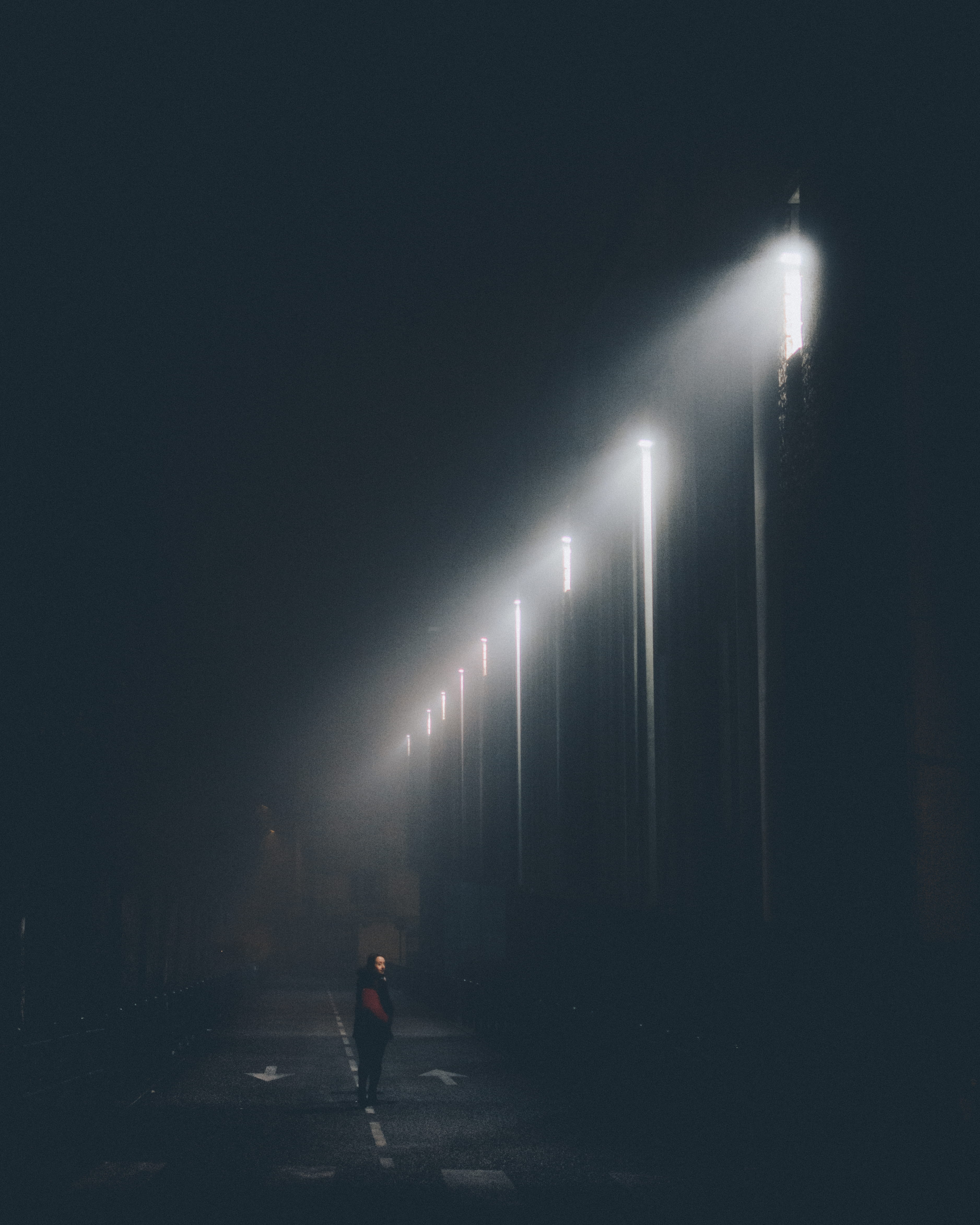 focus, outdoors, woman, street, standing, person, direction, illuminated, city, evening, full length, lights, lamp posts, fog, landscape, urban, the way forward, Phone HD Wallpaper