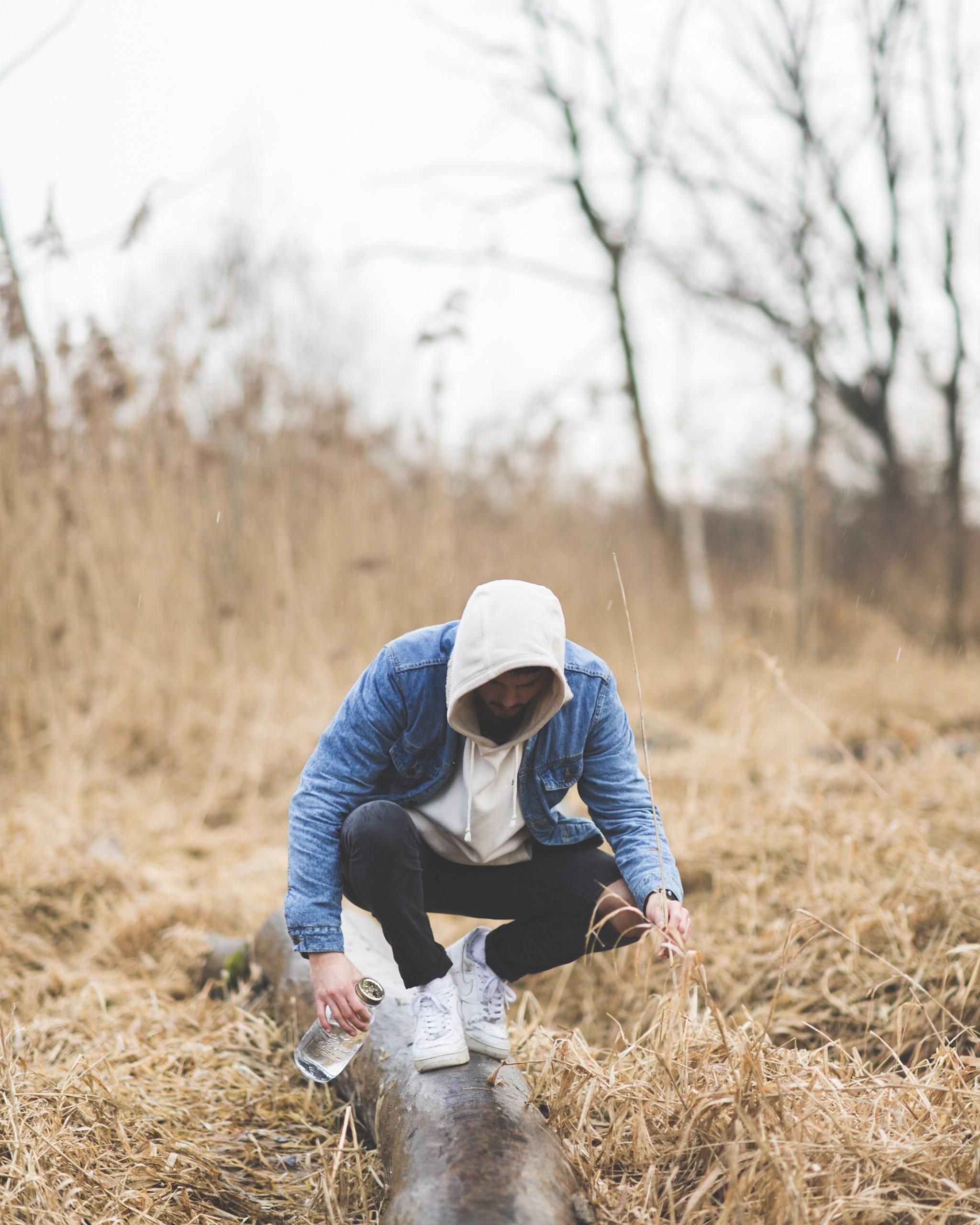 hoodie, front view, focus on foreground, holding, leisure activity, bottle, standing, male, hood - clothing, lifestyles, nature, planting, outdoors, plant, Phone HD Wallpaper