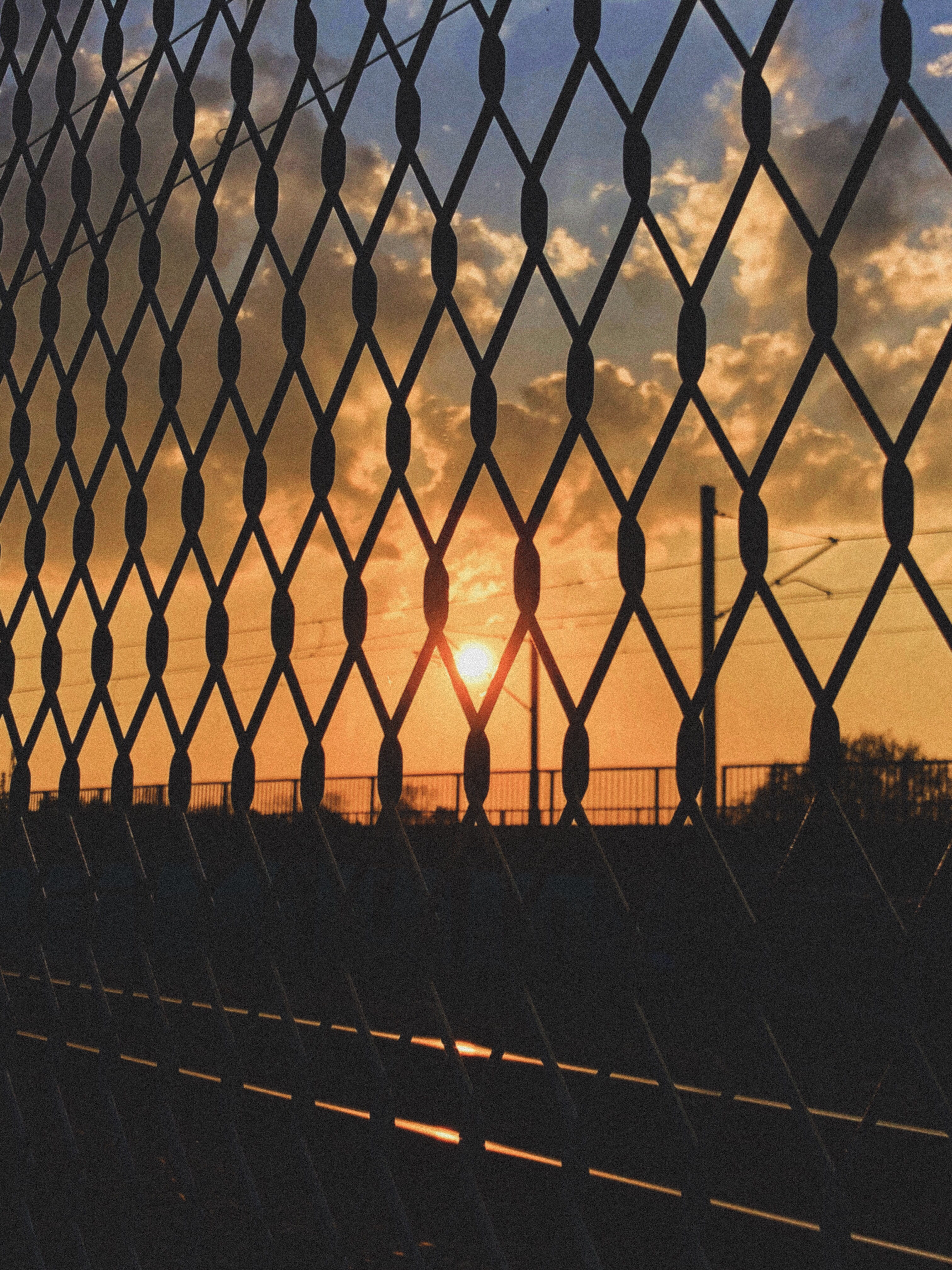 real people, road, linked fence, grainy, sun, sky, protection, transportation, tracks, chainlink fence, 4K, clouds, barrier, metal, wires, nature, safety, Phone HD Wallpaper