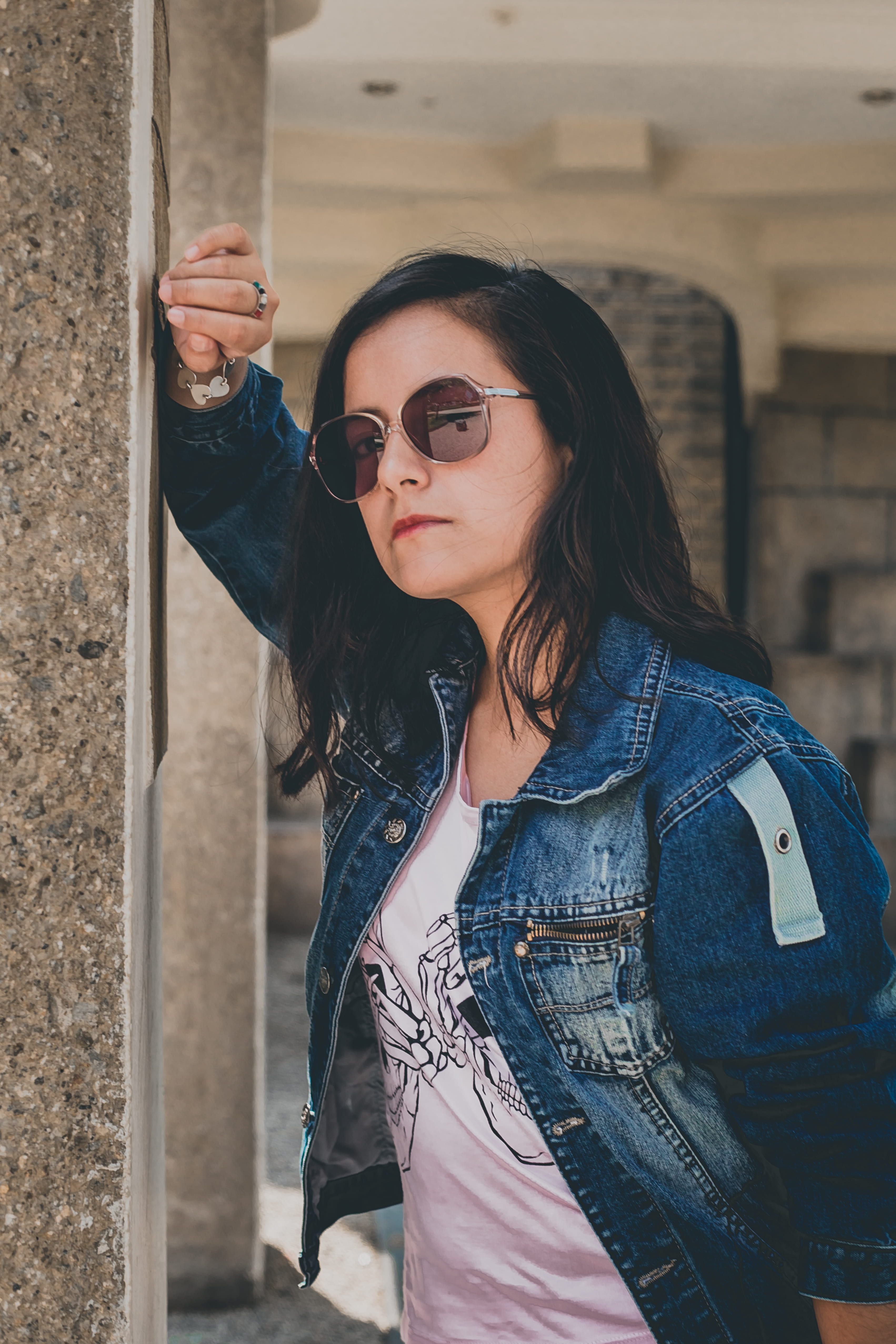 wall, stone, wearing, posing, woman, concrete, female, brunette, lady, real people, fashion, serious, outdoors, long hair, @coffee_wanderer, lifestyles, Phone HD Wallpaper