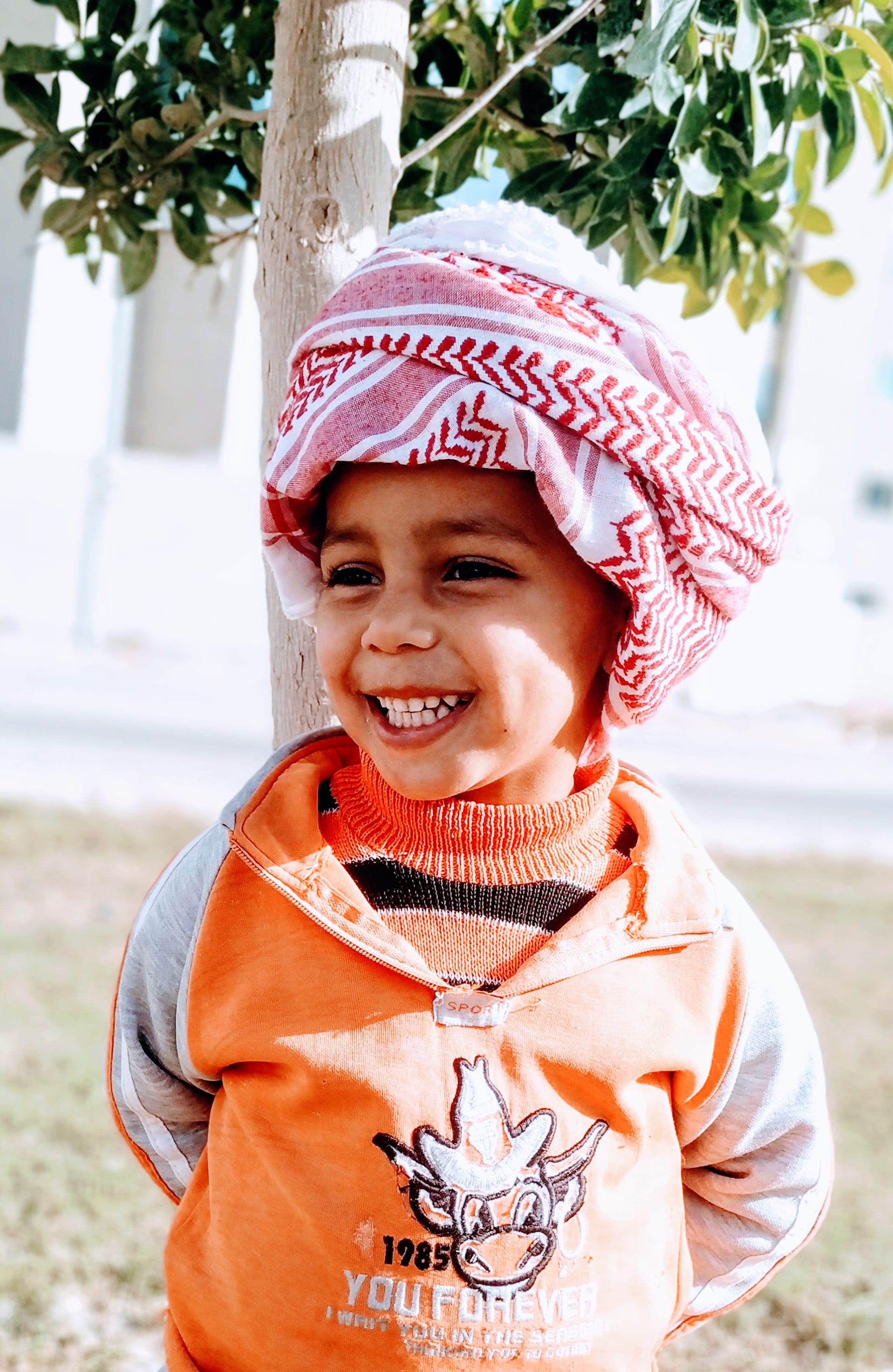 laughing, near, boy, focus on foreground, hairstyle, portrait, looking at camera, front view, tree, childhood, day, one person, nature, outdoors, little, Phone HD Wallpaper
