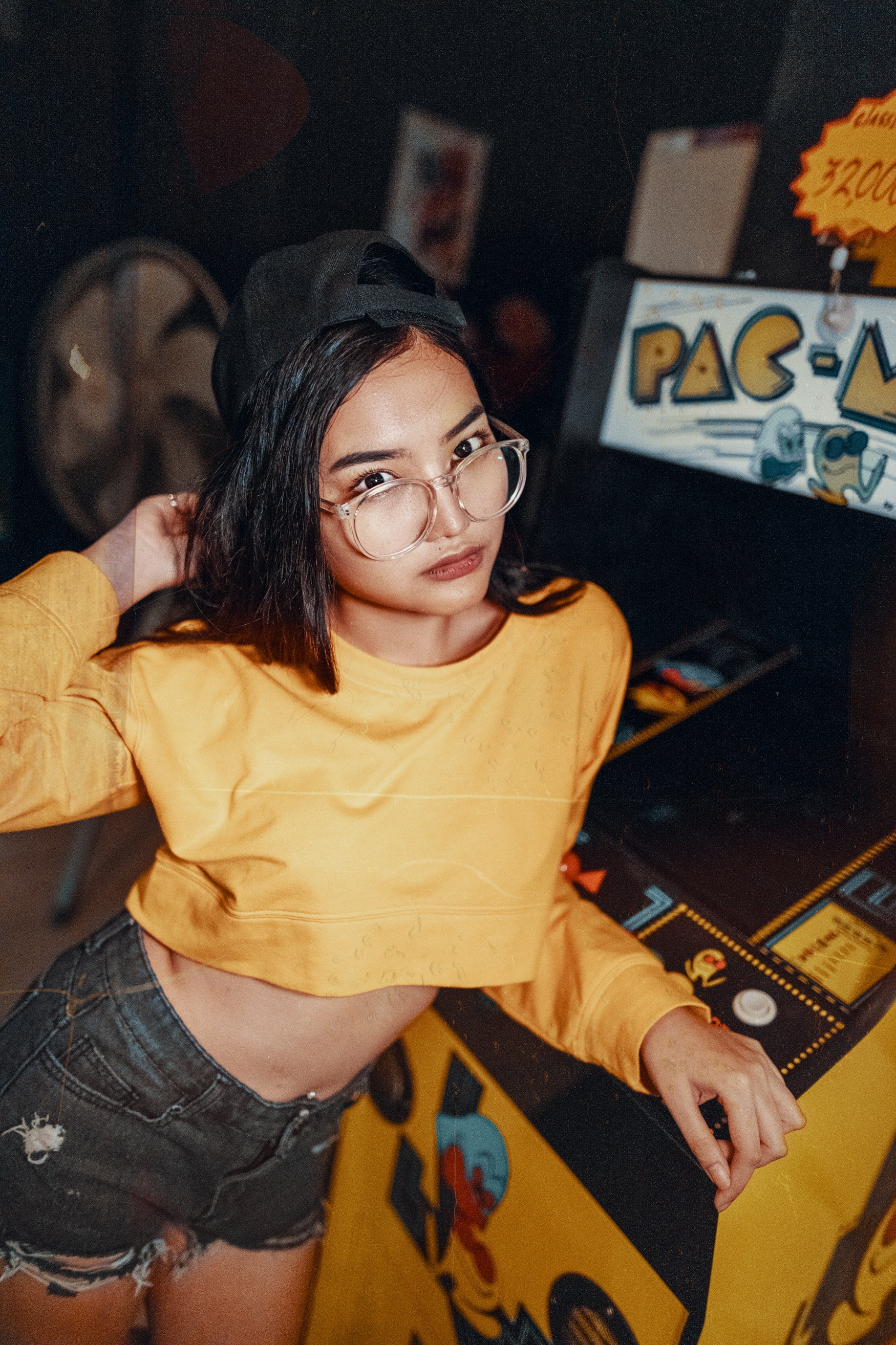 arts culture and entertainment, indoors, dark hair, glasses, young adult, technology, clothing, hair, holding, one person, 2K, young women, Snapback, home interior, Phone HD Wallpaper