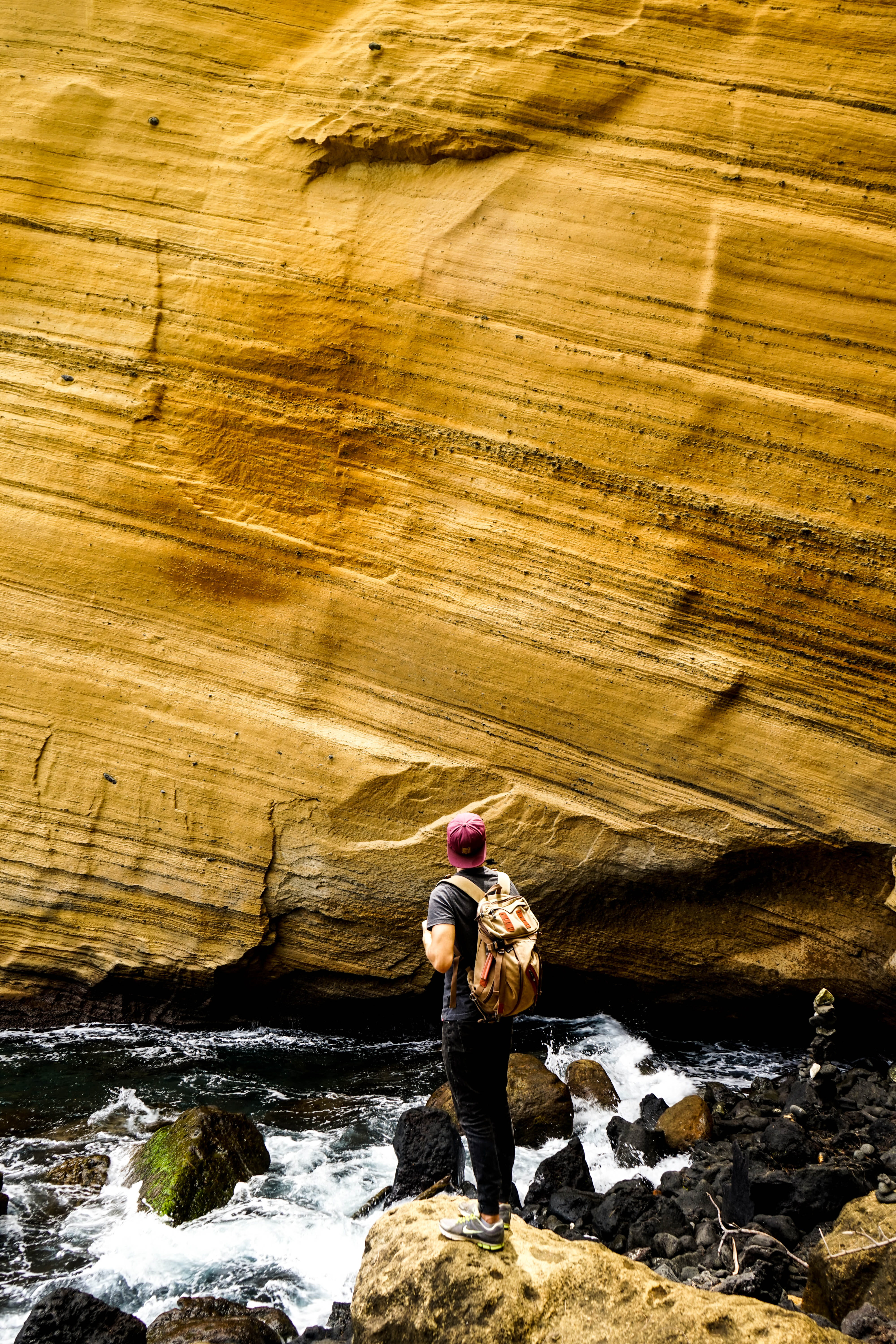 casual clothing, one person, day, wall, men, yellow, rock, environment, outdoors, non-urban scene, travel, stone, backpack, adult, perspective, full length, Phone HD Wallpaper
