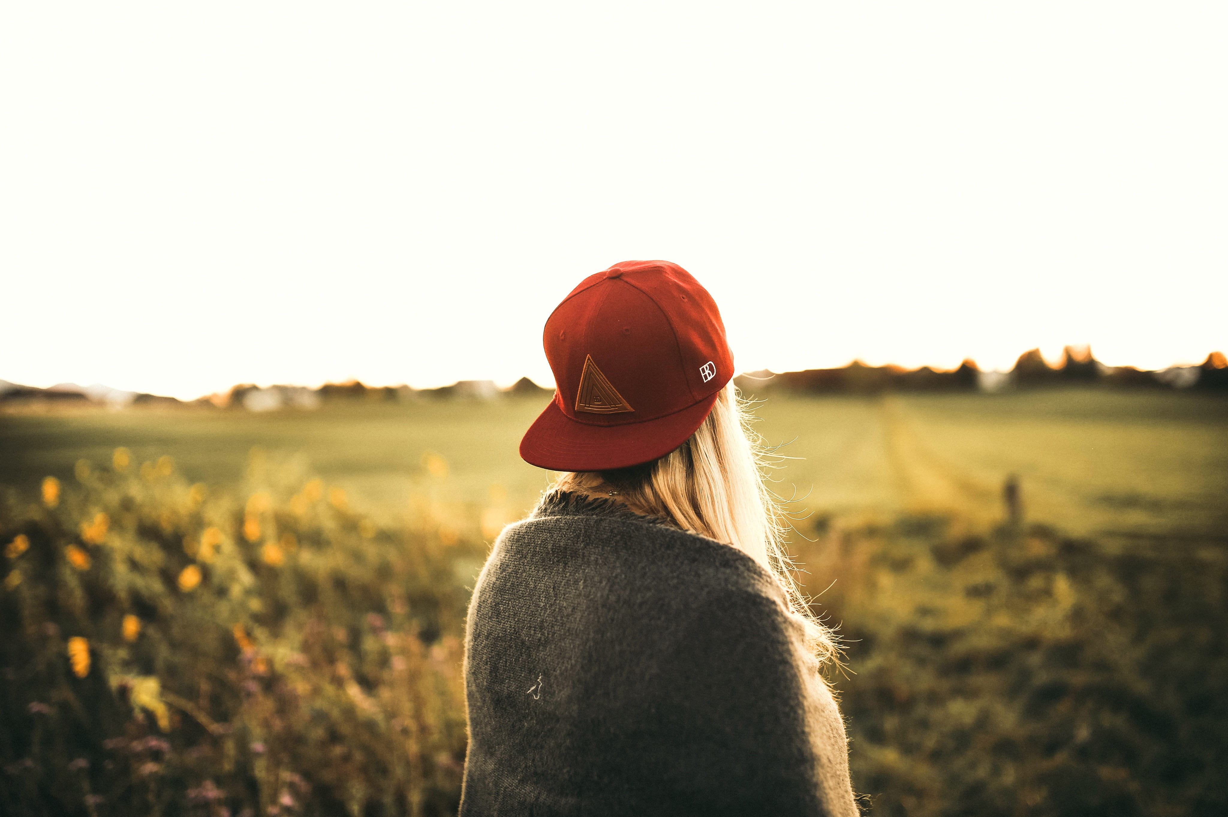 trees, grass, casual clothing, cap, lens flare, nature, looking at view, blonde hair, outdoors, plants, cardigan, wear, landscape, woman, waist up, snapback, HD Wallpaper