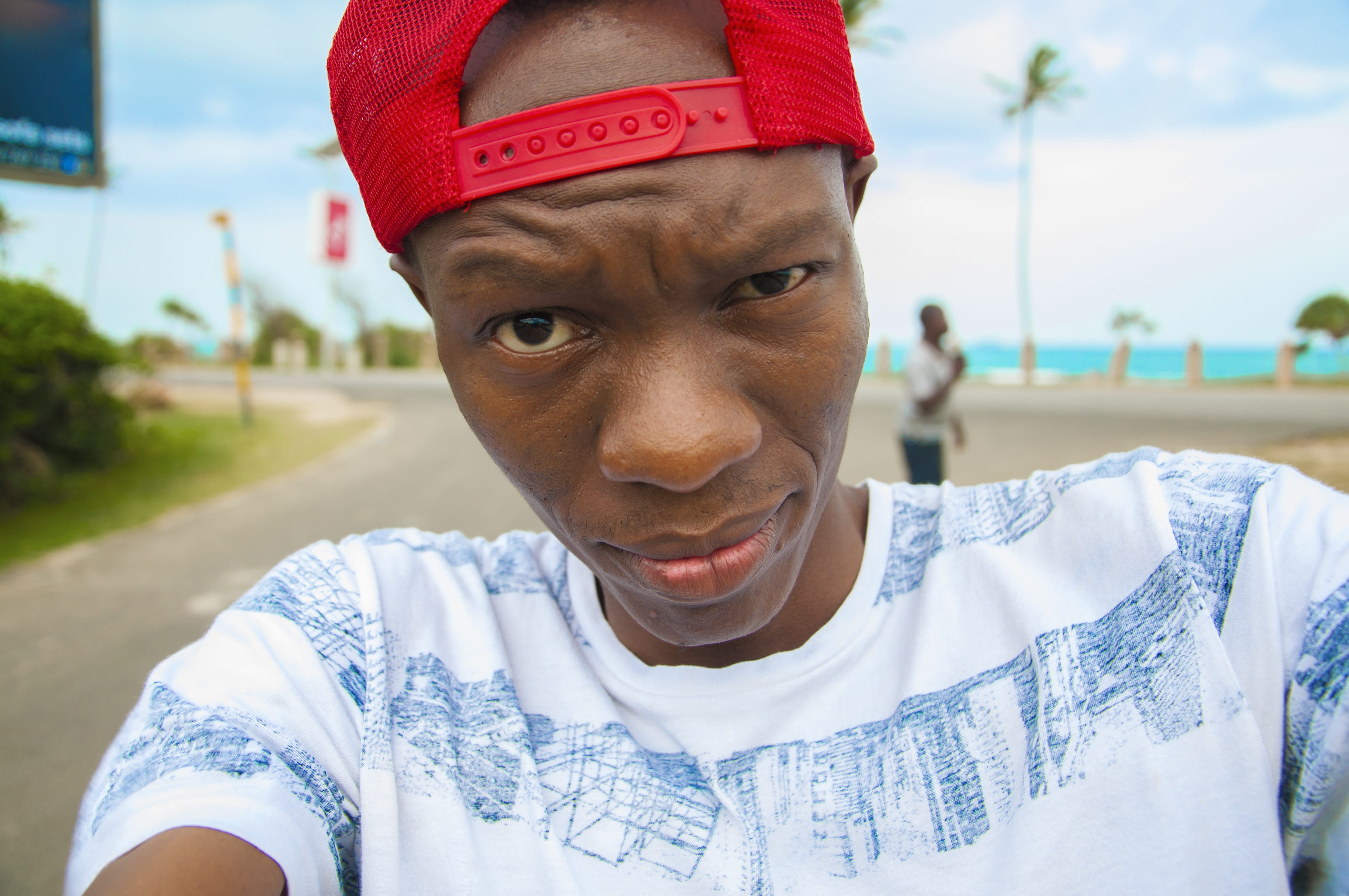 young black adult, young men, cap, closeup, mouth open, 4K, casual clothing, a black man, one person, outdoors, focus on foreground, red, front view, males, HD Wallpaper