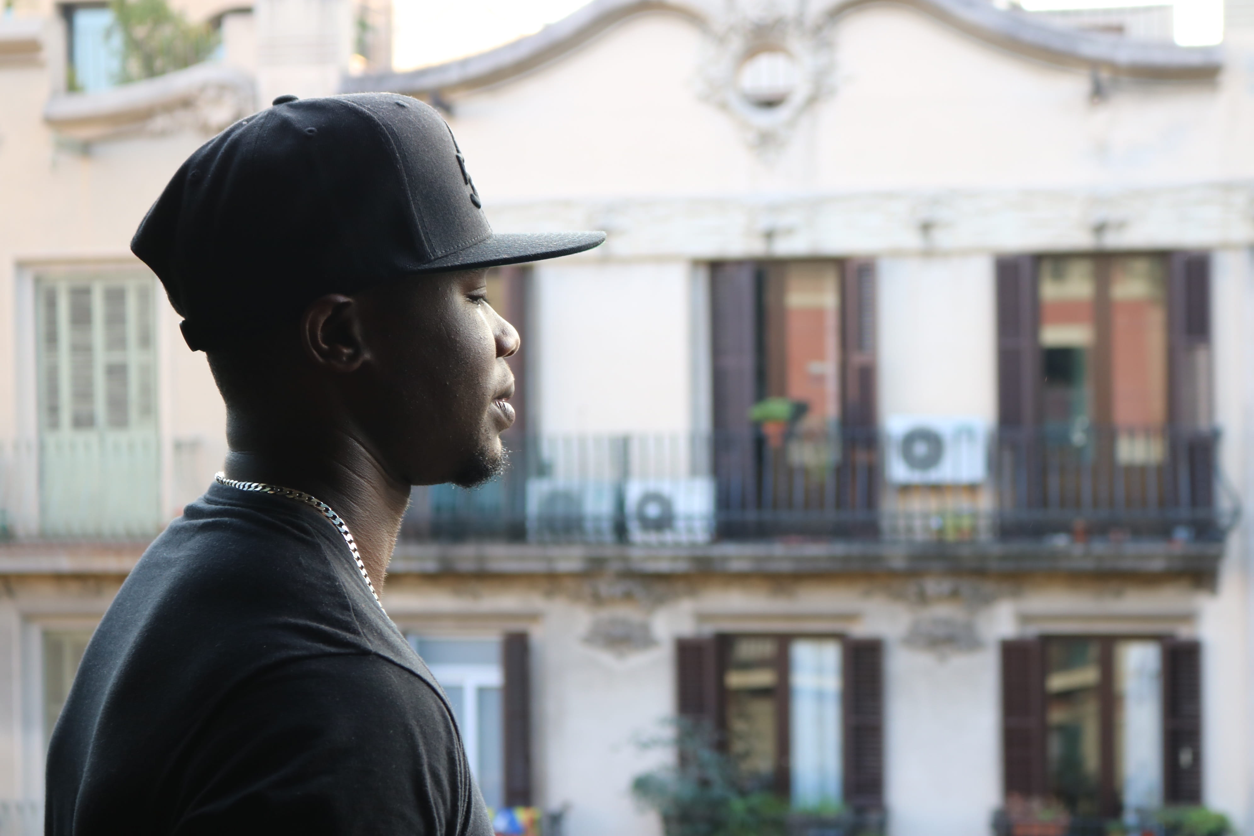 black model, vacation, focus on foreground, young man, looking sideways, tourist, built structure, looking down, representation, only men, lifestyles, side view, HD Wallpaper