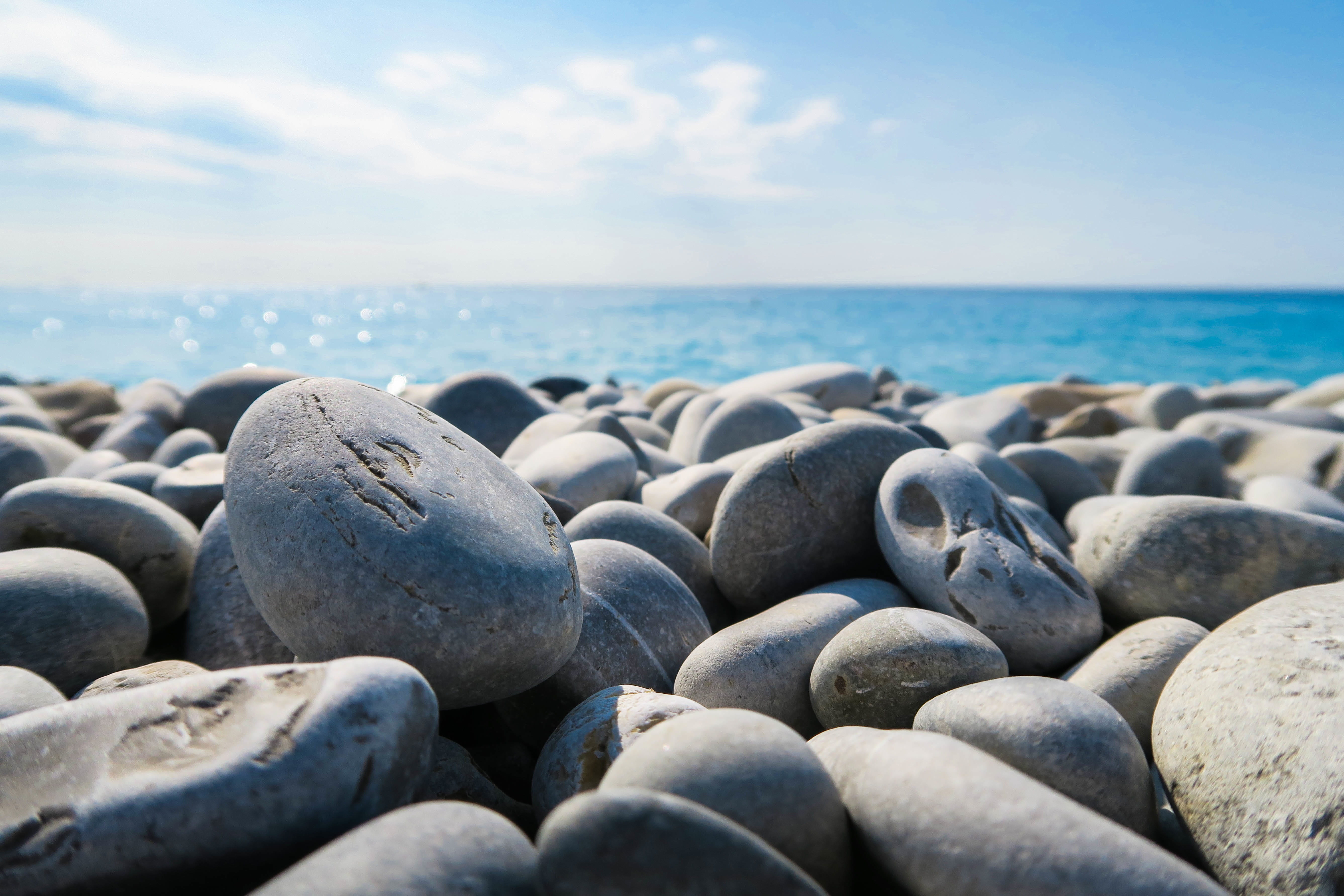 seaside, coastline, rock, stone - object, smooth rocks, tranquil scene, vacation, selective, ocean, sand, blue, seascape, solid, stones, beach, naure, horizon over water, HD Wallpaper