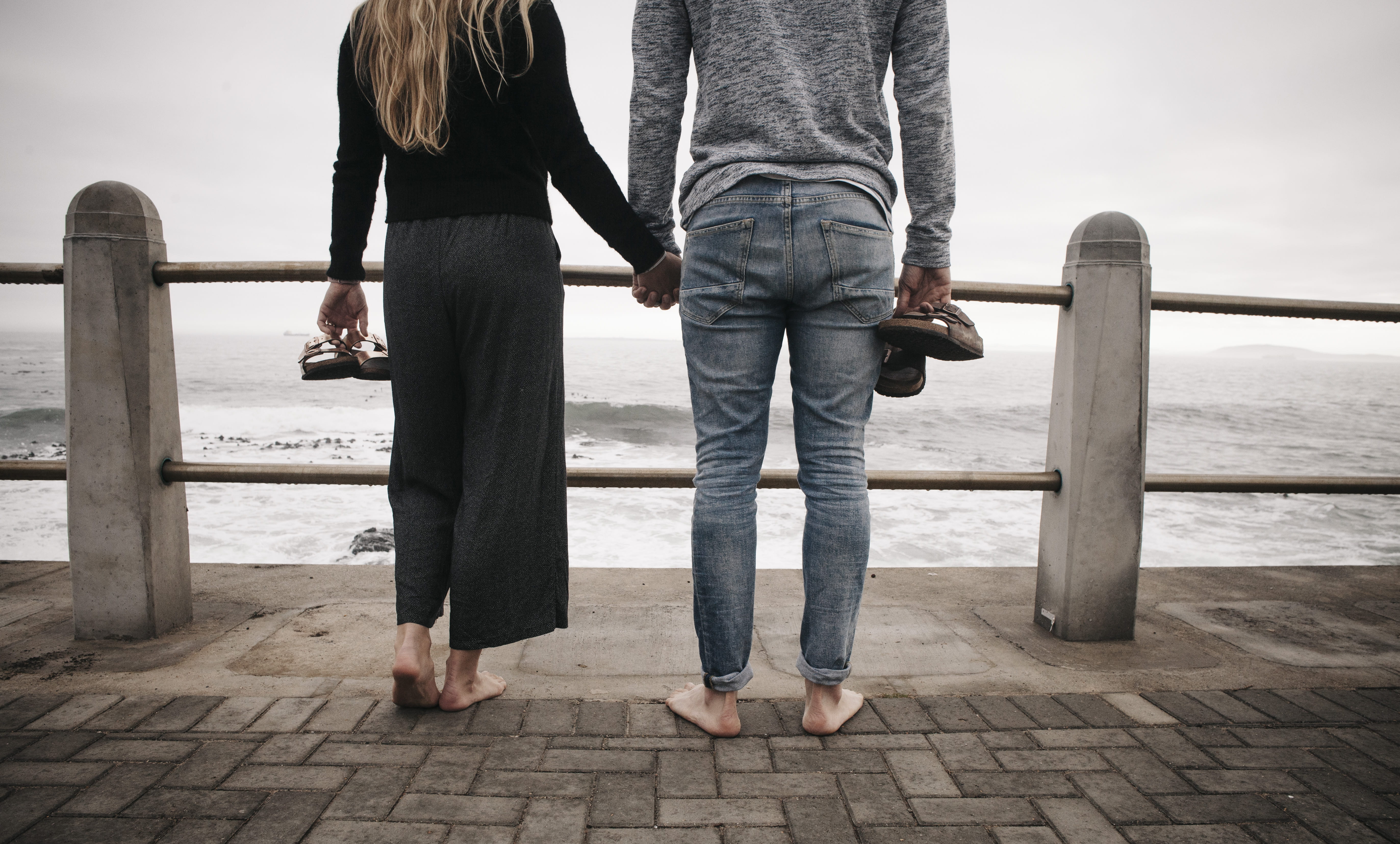 from behind, couple, railing, people, woman, 5K, heterosexual couple, positive emotion, bare feet, travel, outdoors, lifestyles, hands, jeans, women, shoreline, HD Wallpaper