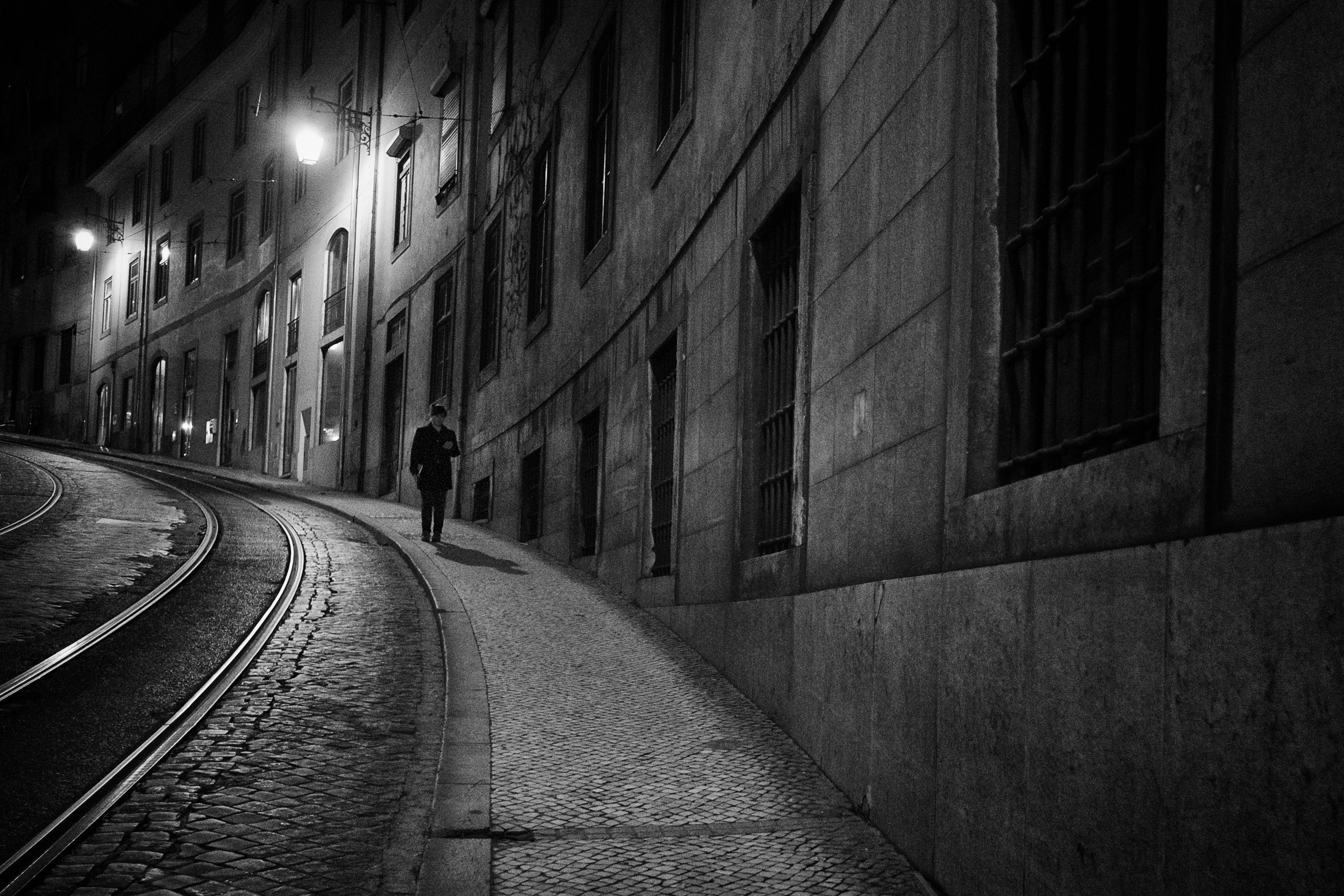 outdoors, illuminated, photo, rear view, track, 2K, real people, grayscale, beside, direction, men, building, building exterior, alley, road, night, built structure, HD Wallpaper
