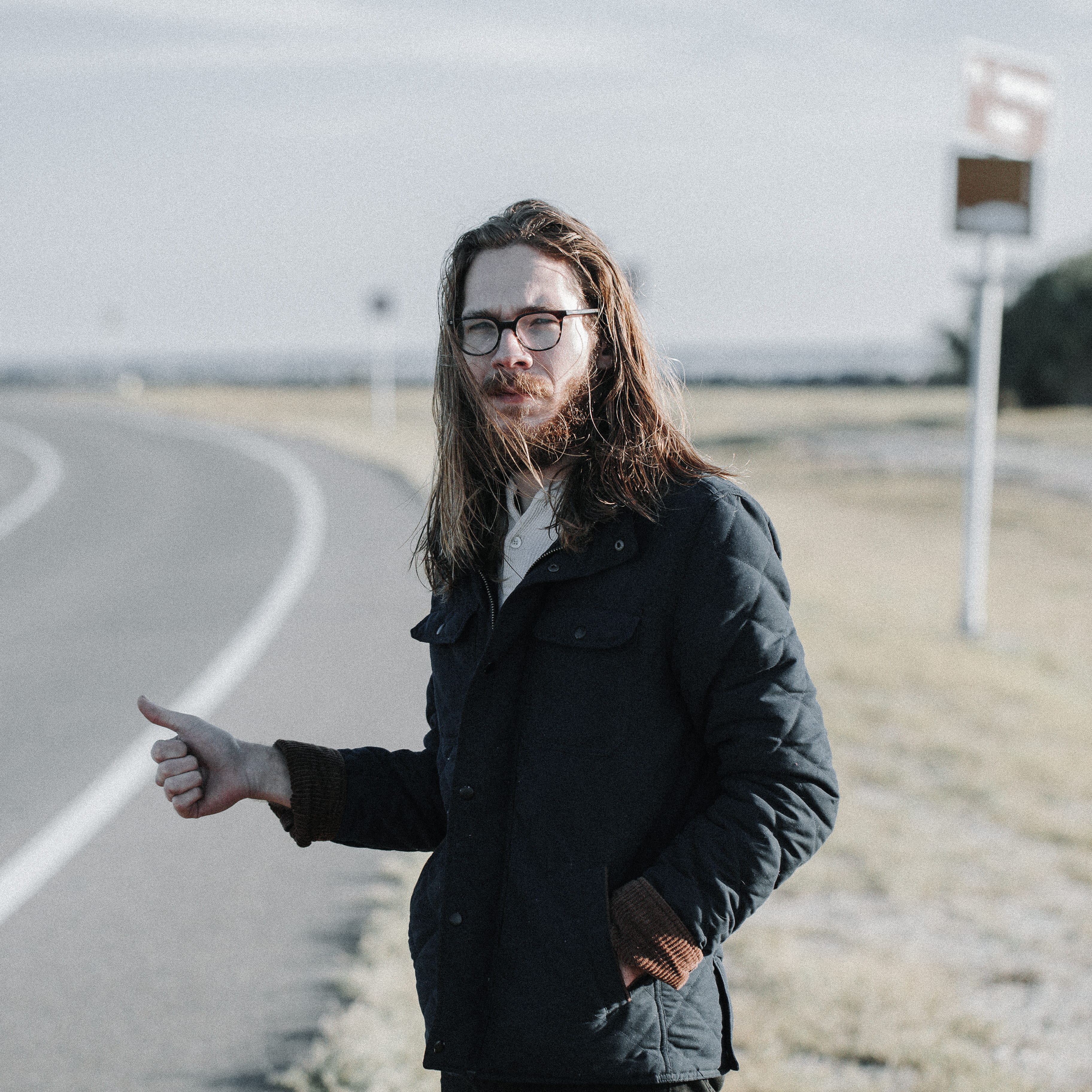 hitchhiker, hitchhike, front view, one person, beard, waist up, thumb, male, caucasian, hairstyle, city, hair, coat, street, three quarter length, young adult, Phone HD Wallpaper