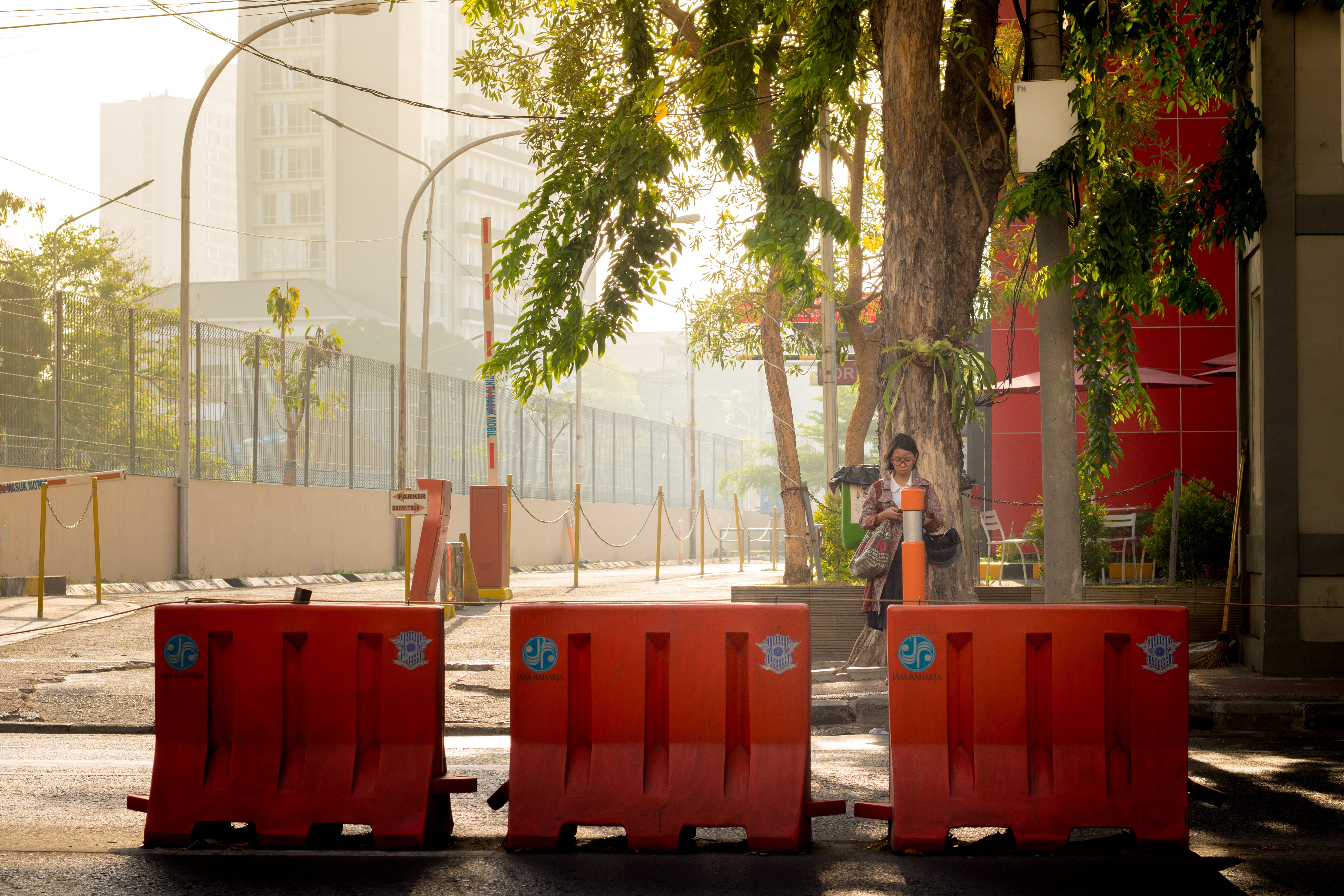 built structure, red, one person, street, garbage bin, architecture, building, lifestyles, outdoors, day, jalan basuki rahmat, indonesia, 5K, tree, plant, HD Wallpaper