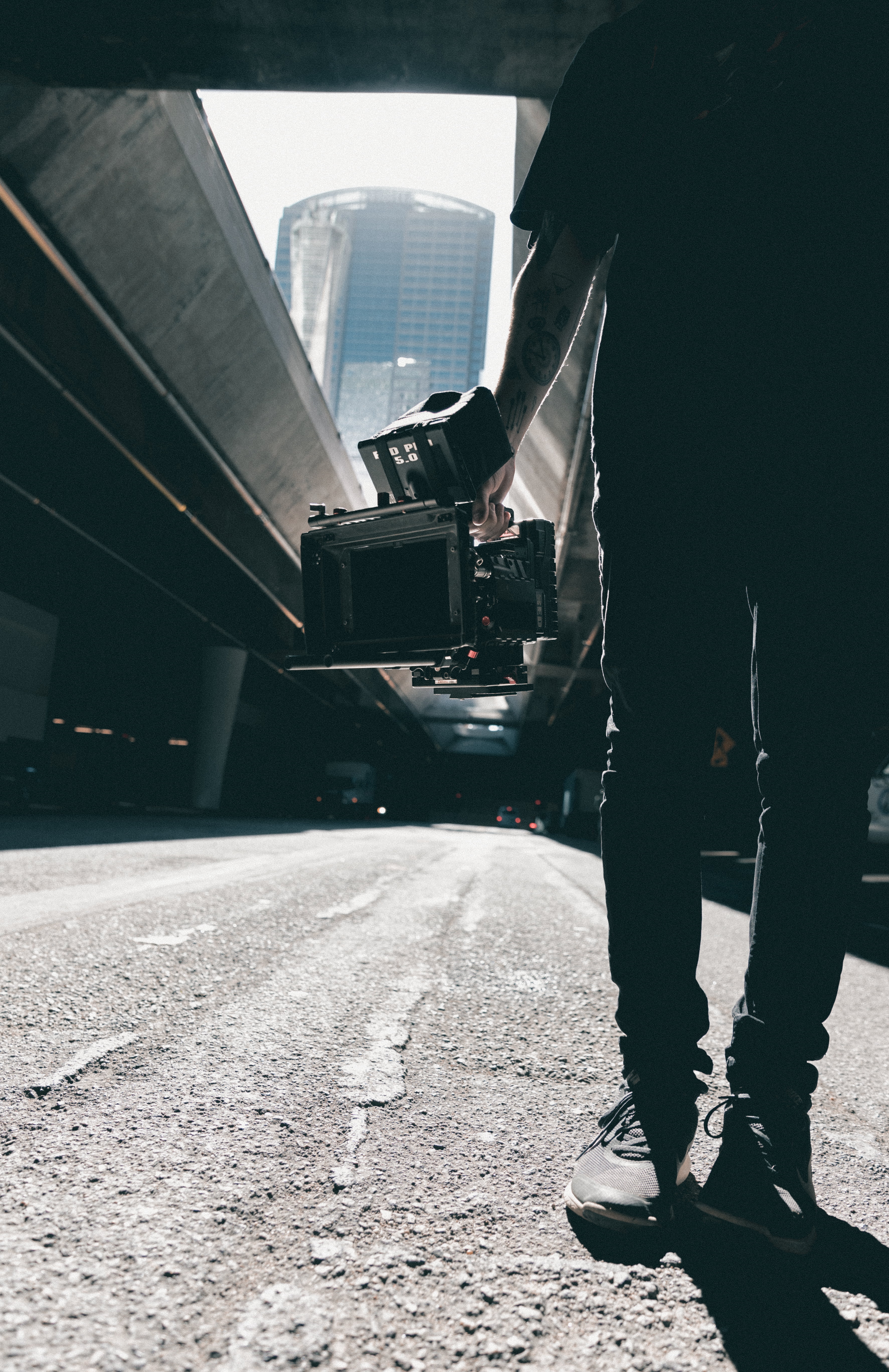 silhouette, architecture, human limb, one person, pavement, transportation system, day, daylight, camera, adult, real people, human leg, street, outdoors, Phone HD Wallpaper