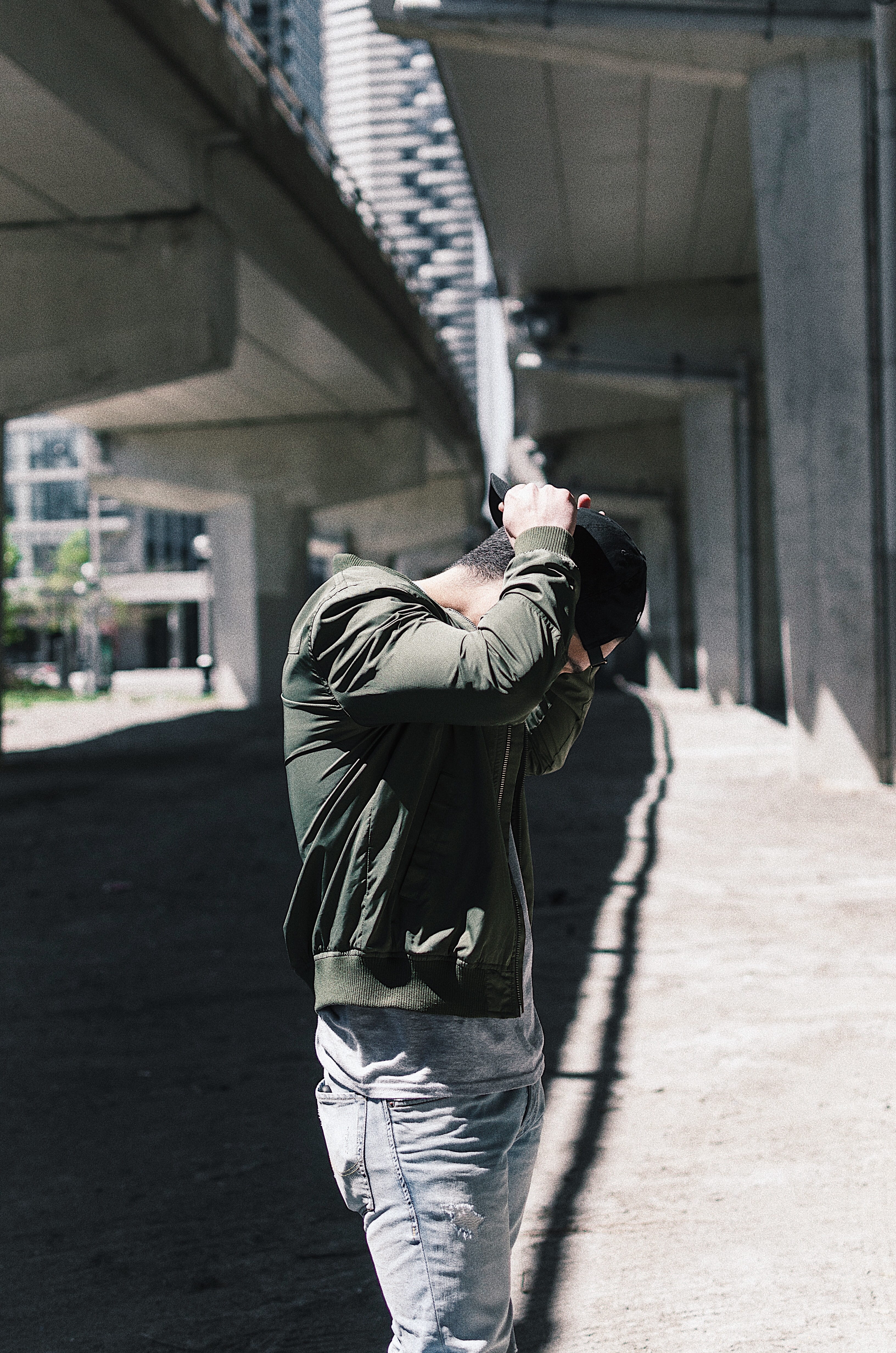 shadow, real people, fixing, black, day, walking, person, sunlight, overpass, boyfriend, hat, men, green, solitude, jeans, transportation, daytime, outdoors, Phone HD Wallpaper