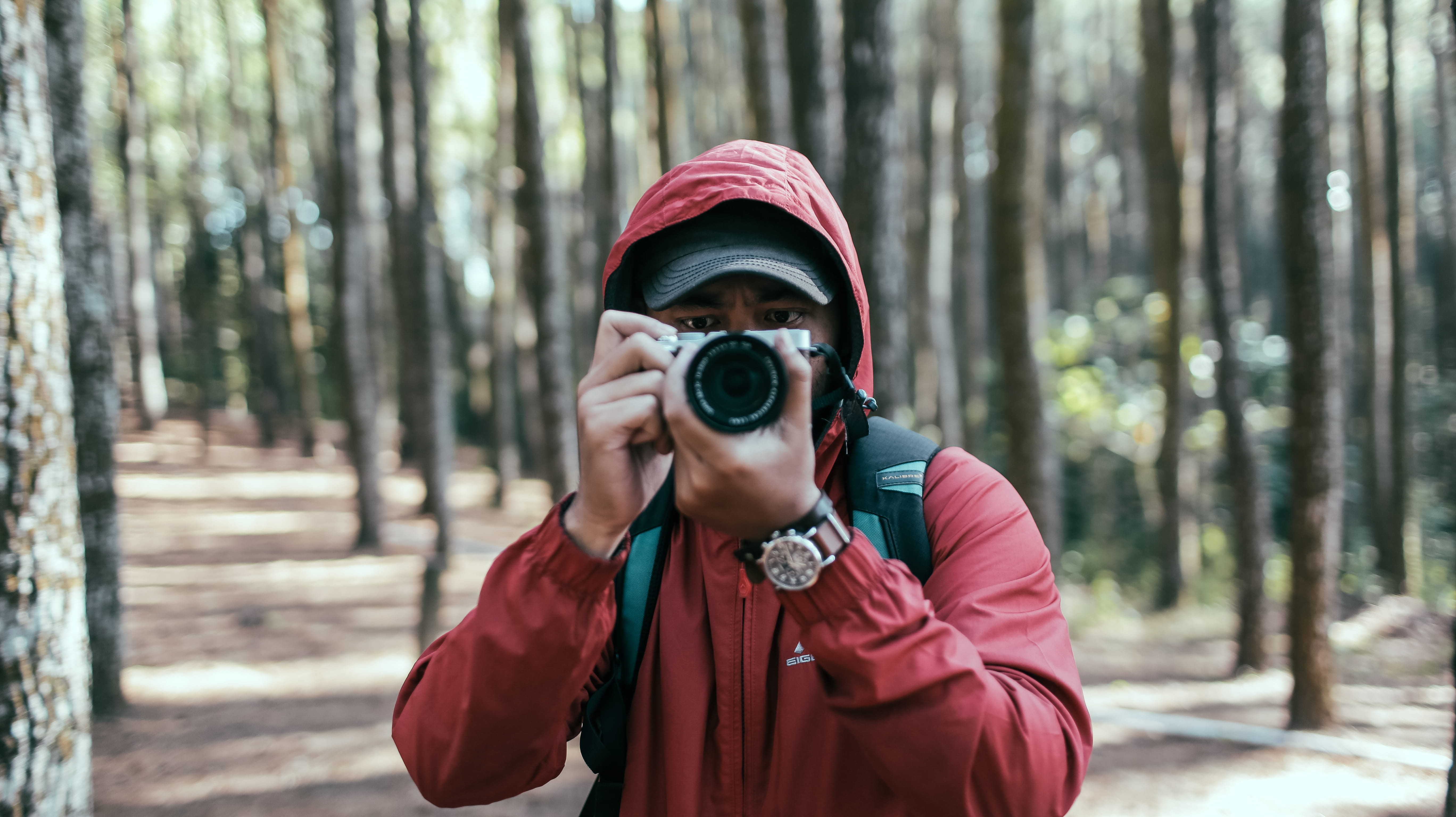 warm clothing, jacket, real people, technology, watch, adult, outdoors, hiking, holdin, young adult, daytime, standing, forest, waist up, camera, taking photo, HD Wallpaper