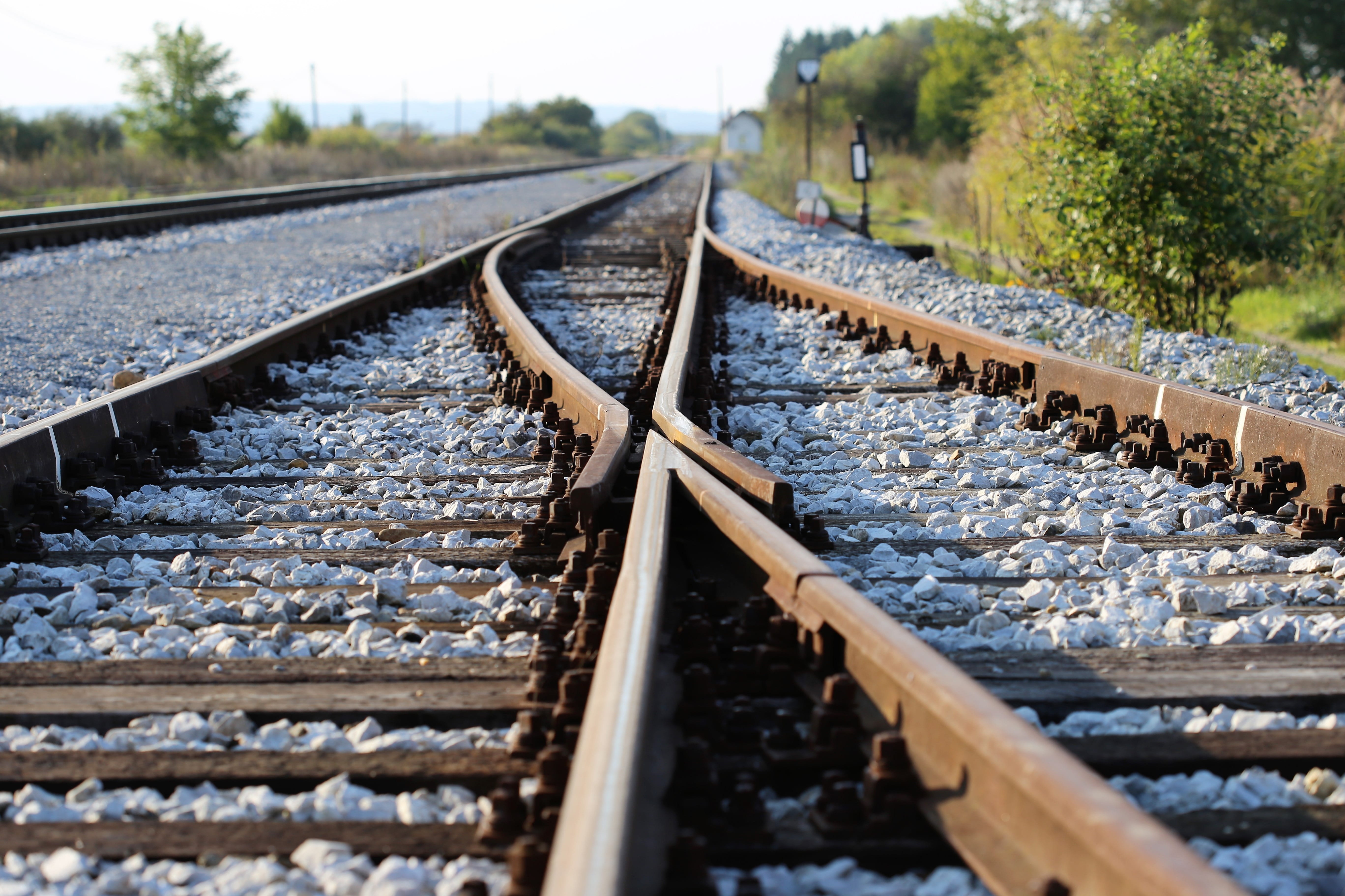 selective focus, track, 5K, railroad track, outdoors, day, railroad tie, horizon, diminishing perspective, nature, the way forward, plant, gravel, mode of transportation, HD Wallpaper