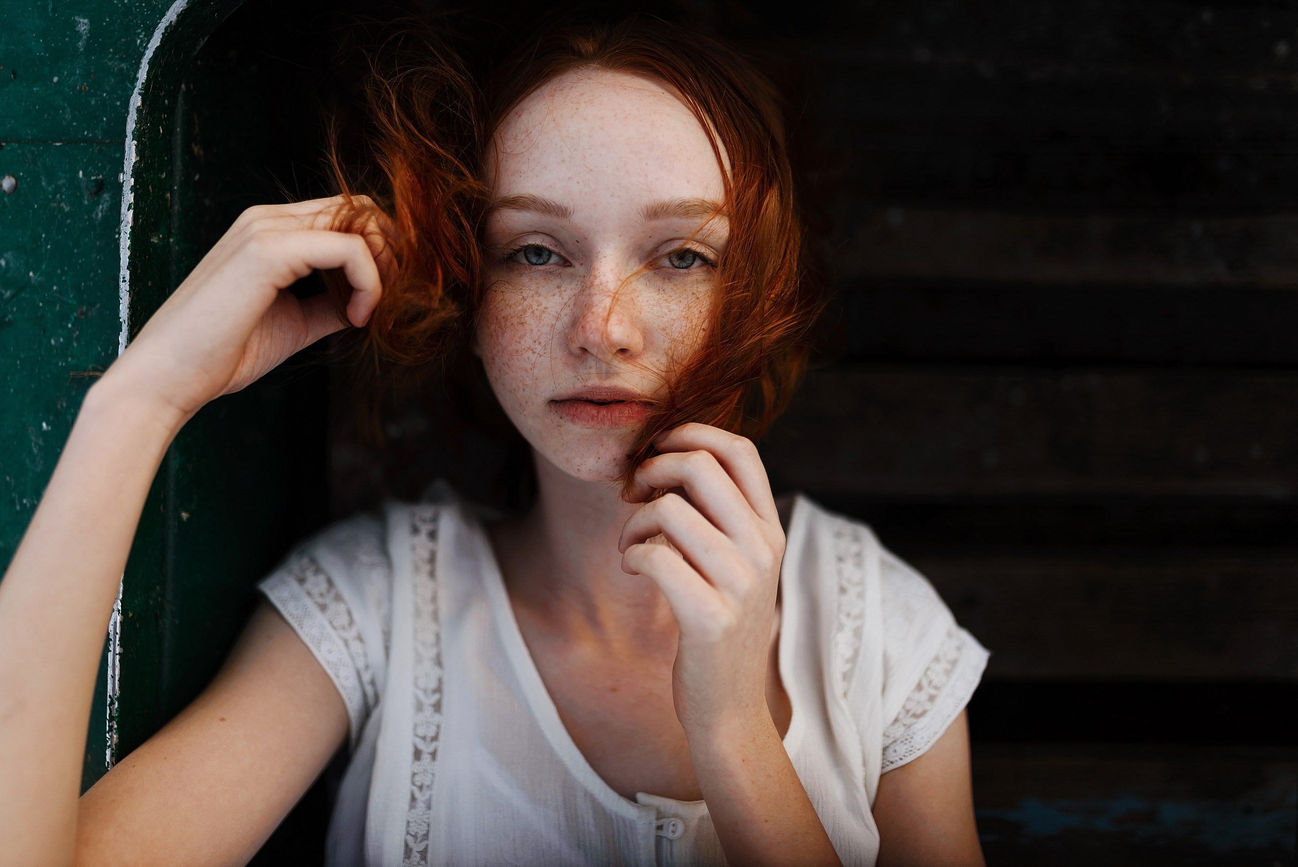 blouses, women, fair skin, outdoors, looking at viewer, depth of field, women outdoors, hair in face, touching hair, redhead, freckles, portrait, hands, HD Wallpaper