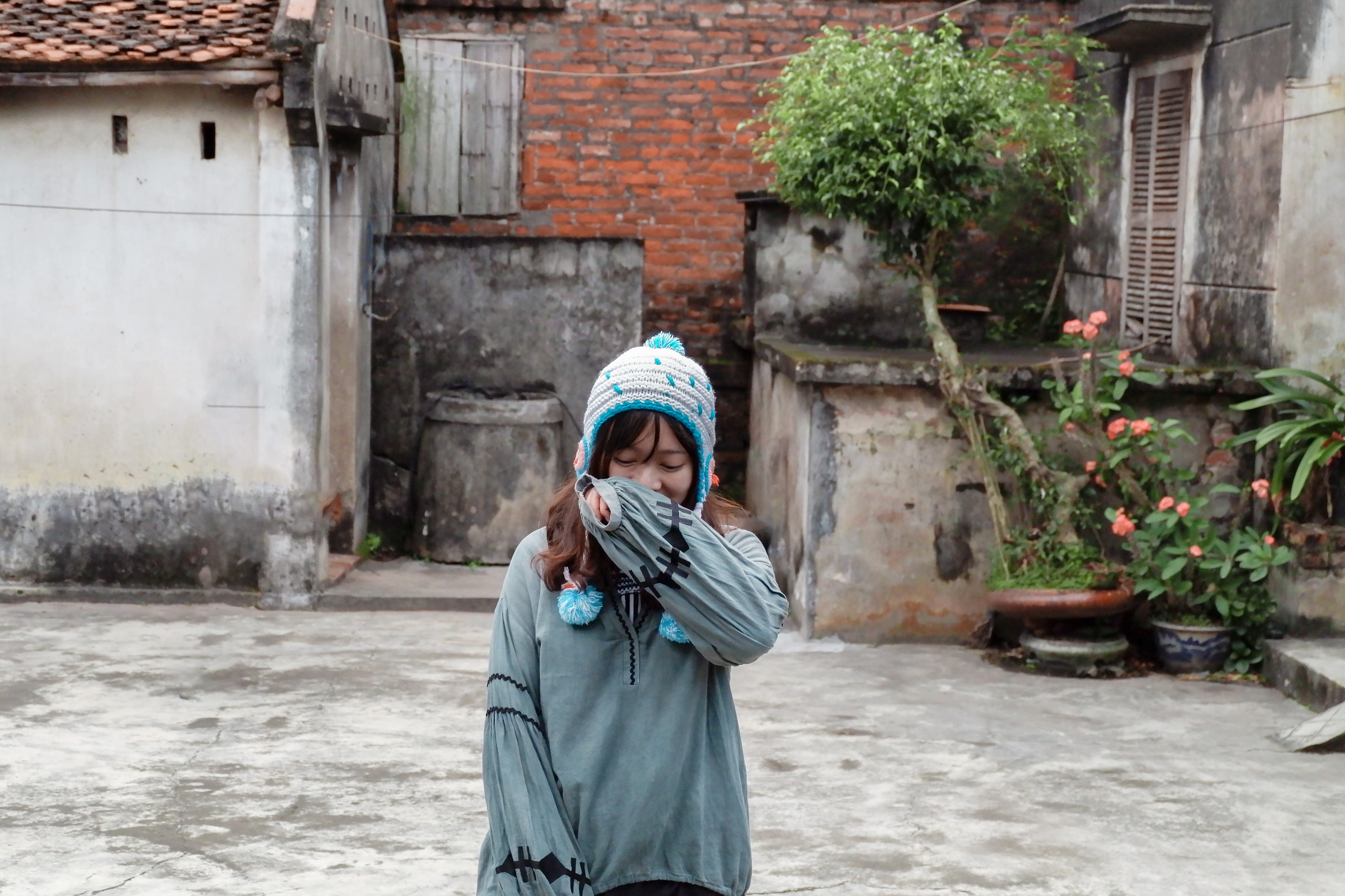 holding, casual clothing, outdoors, waist up, leisure activity, emotion, vietnam, building exterior, front view, standing, building, clothing, 4K, architecture, HD Wallpaper