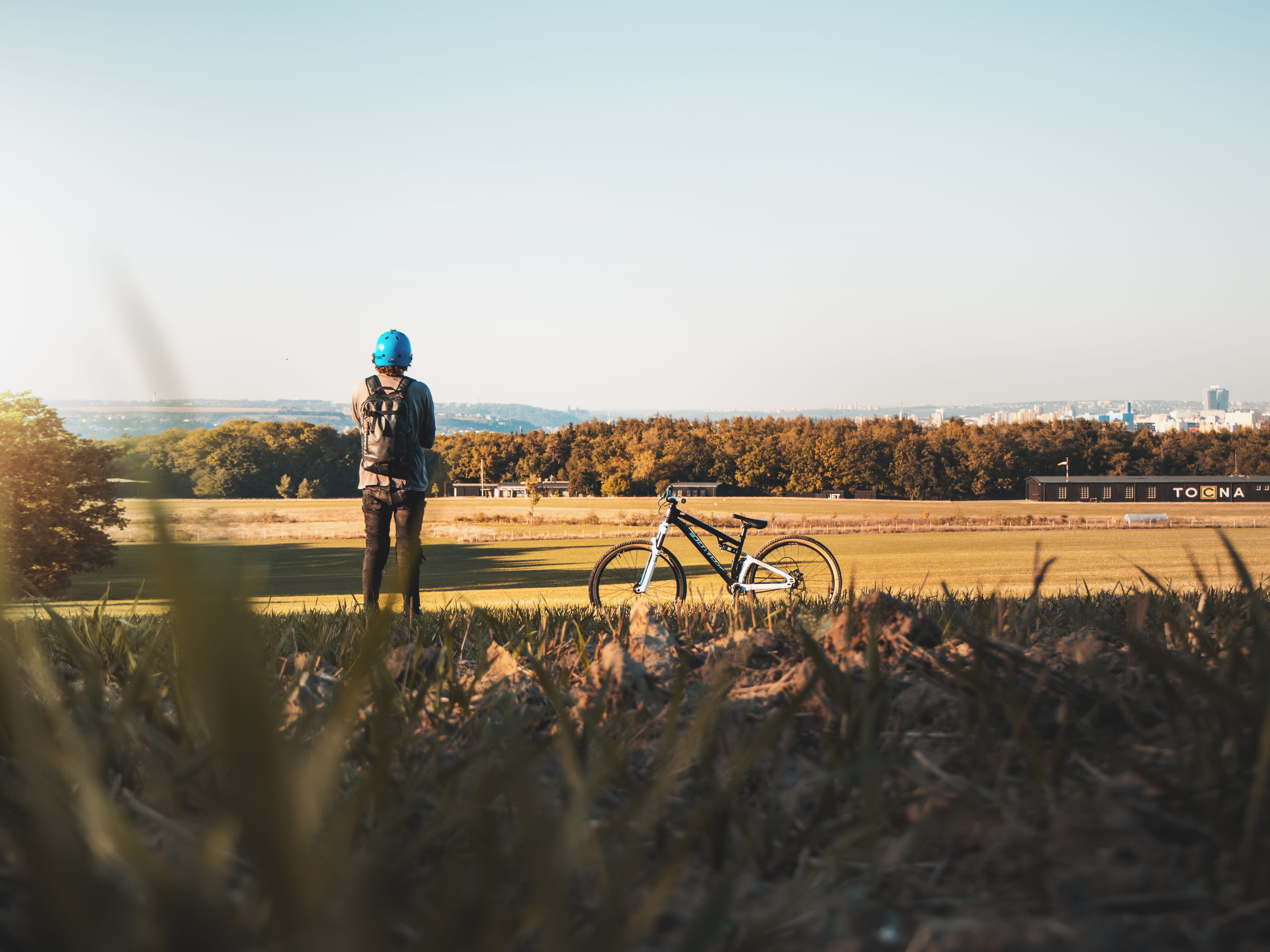 headwear, sunlight, czechia, road, land vehicle, sky, lifestyles, mountain bike, grass, outdoors, grassland, soil, transportation, flora, 4K, gravel, vehicle, HD Wallpaper