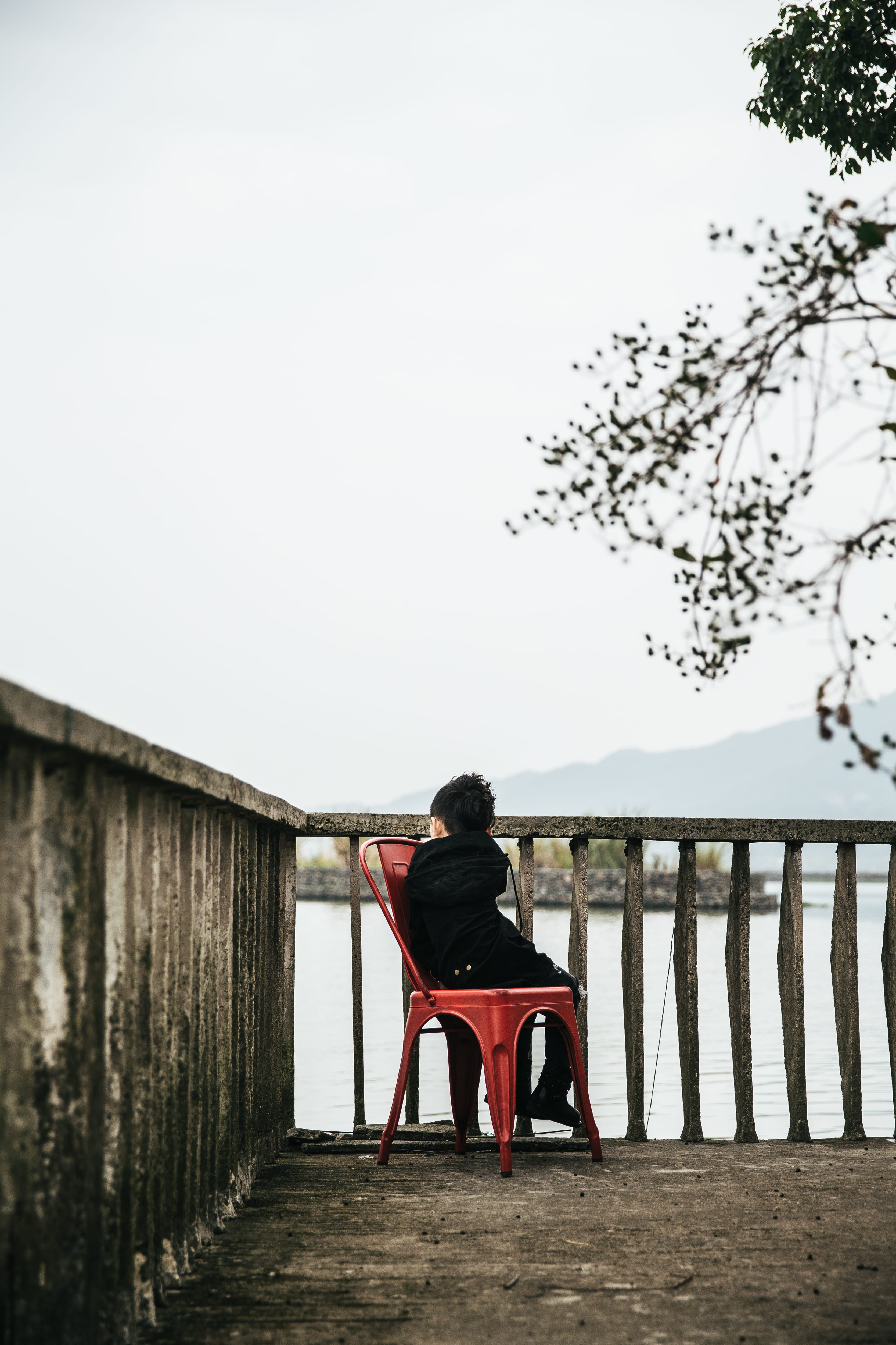 one person, beside, apparel, chair, banister, pants, sky, clothing, nature, railing, gown, outdoors, handrail, furniture, human, seat, street, wood - material, Phone HD Wallpaper