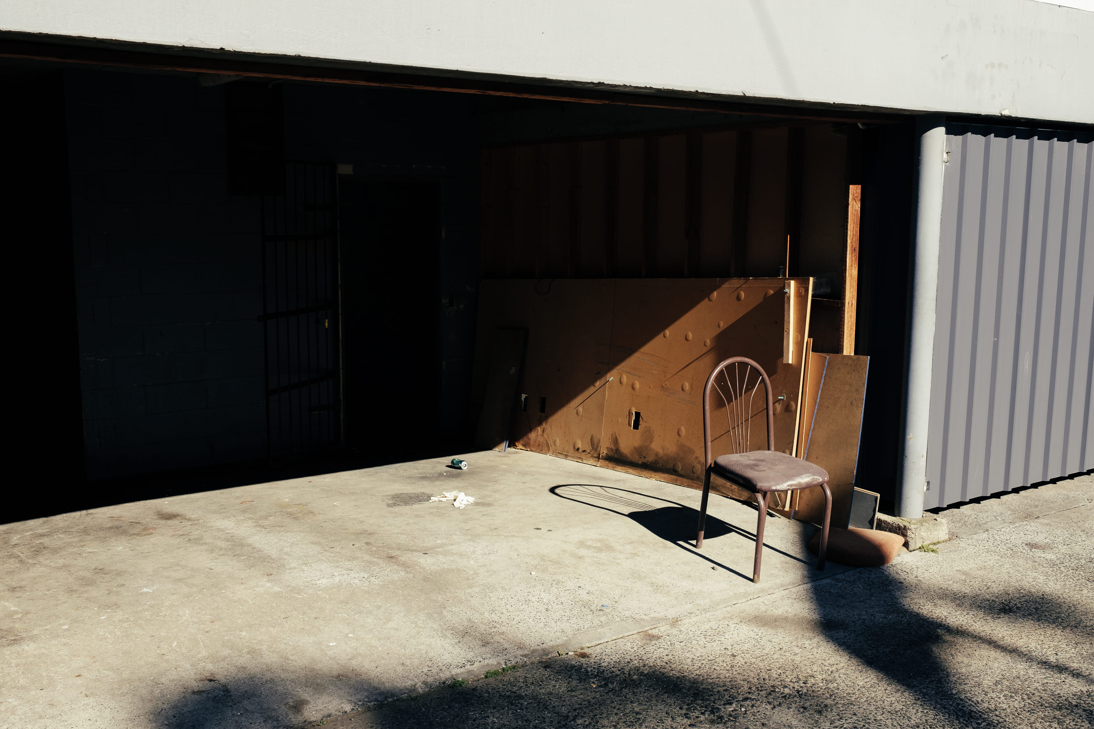 minimal, wall, armless, shadow, furniture, grey, building, brown, plywood, day, 2K, metal, still life, garage, chair, absence, contemporary, wall - building feature, HD Wallpaper