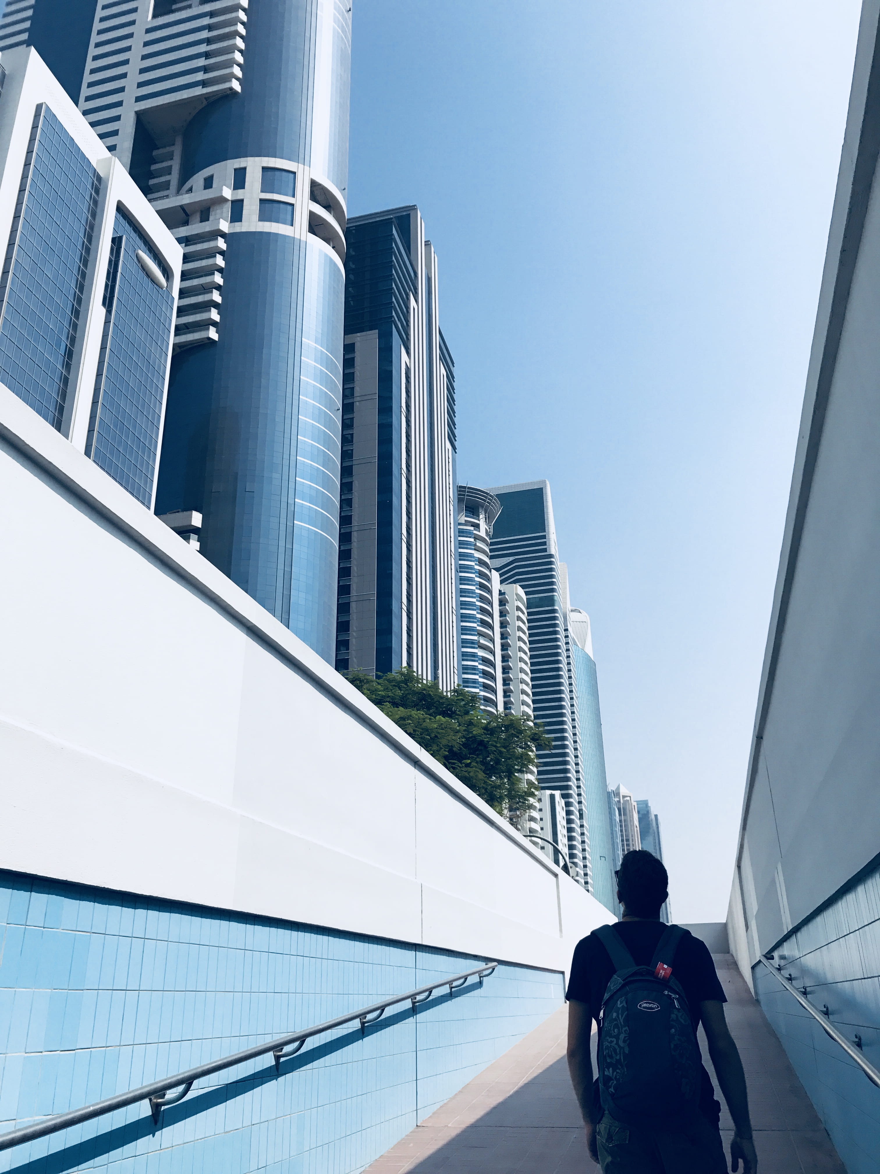 people, women, glass - material, architecture, skyscraper, buildings, walk, nature, tall - high, daytime, inclined, dubai, clear sky, building exterior, Phone HD Wallpaper