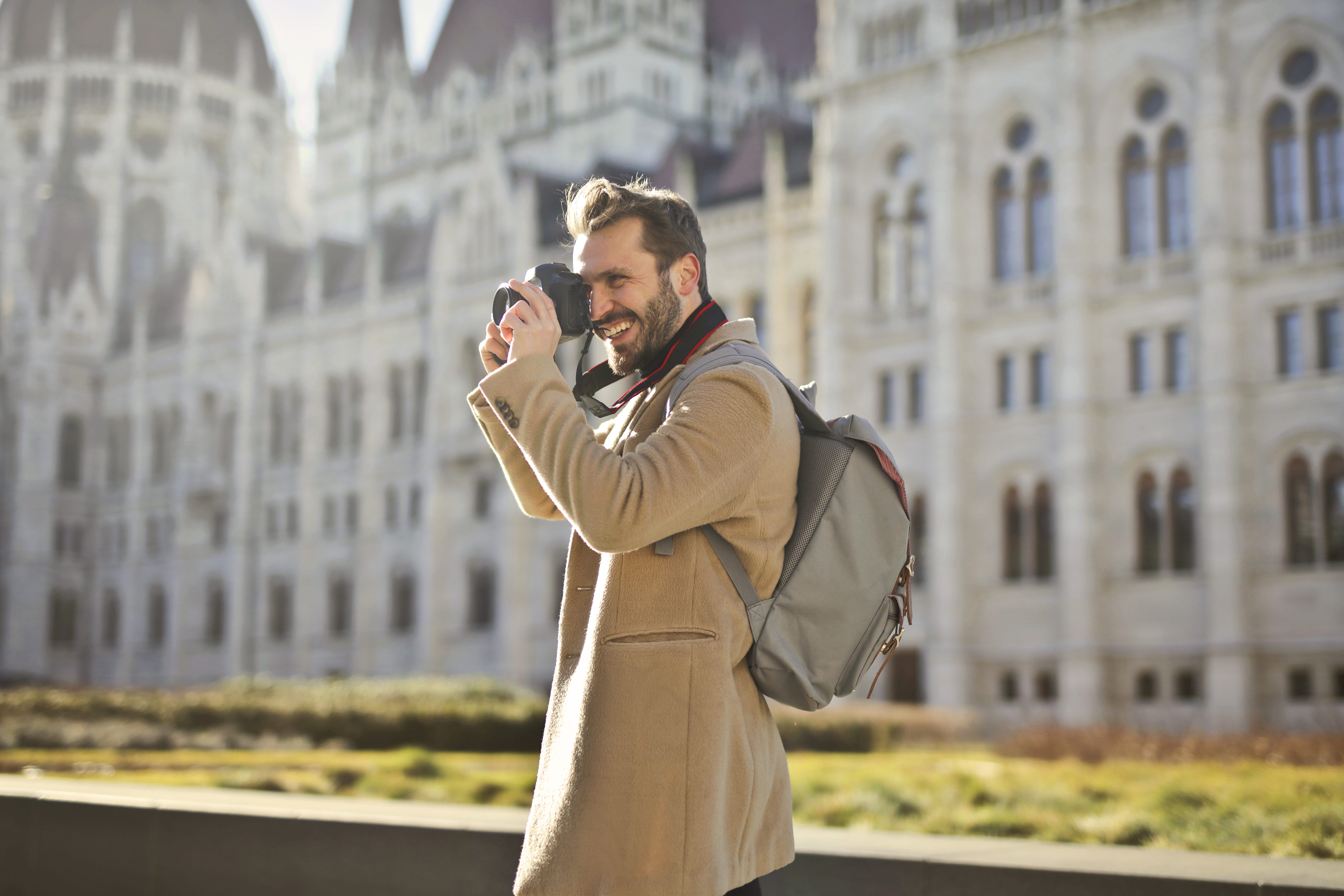 photographer, coat, man, grass, person, around, holding, landmark, outdoors, daylight, technology, camera, travel, 5K, daytime, photography themes, wear, HD Wallpaper