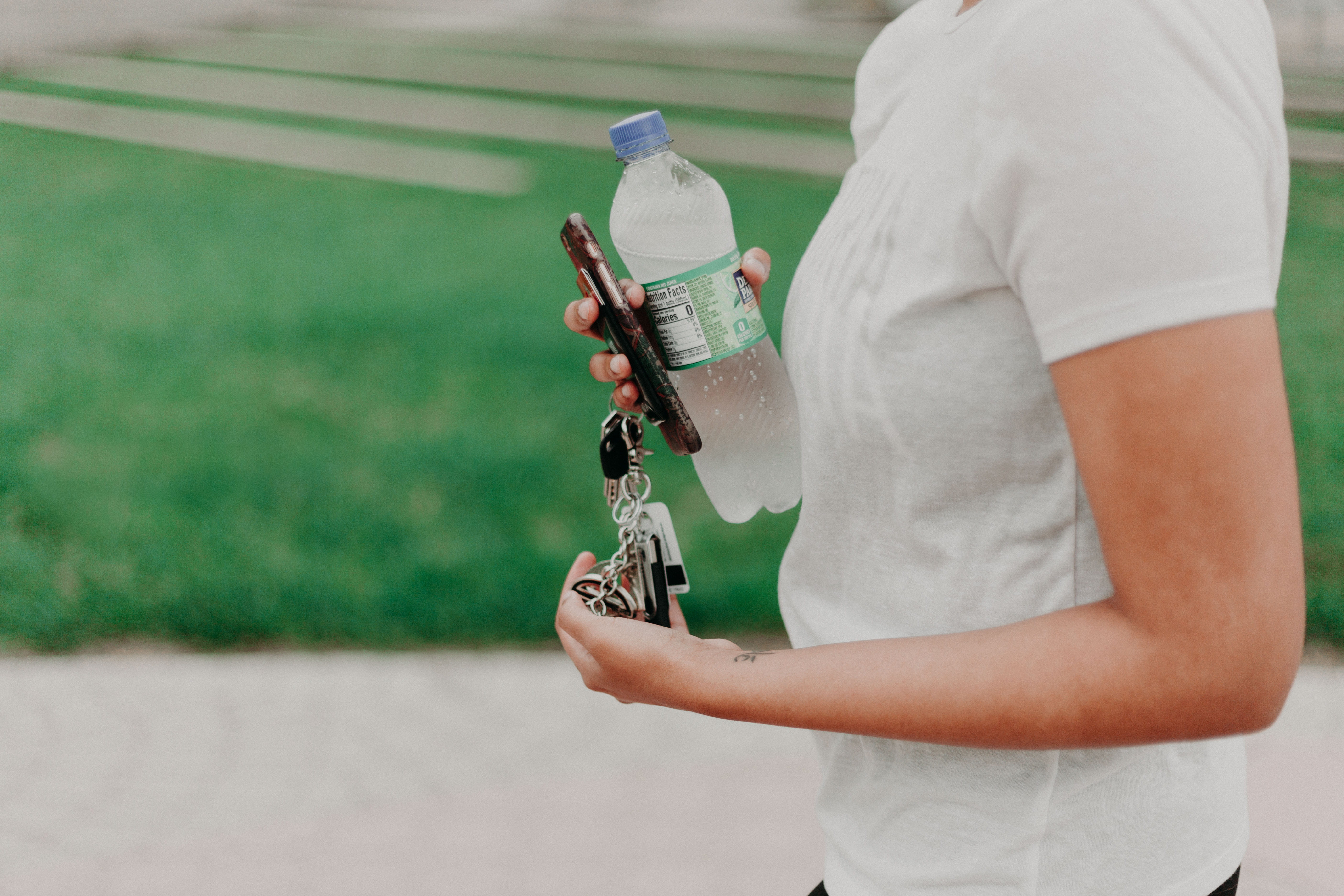 water, motion, day, bottle, car keys, holding, vitality, 5K, person, leisure activity, water bottle, plastic, sports equipment, outdoors, focus on foreground, HD Wallpaper