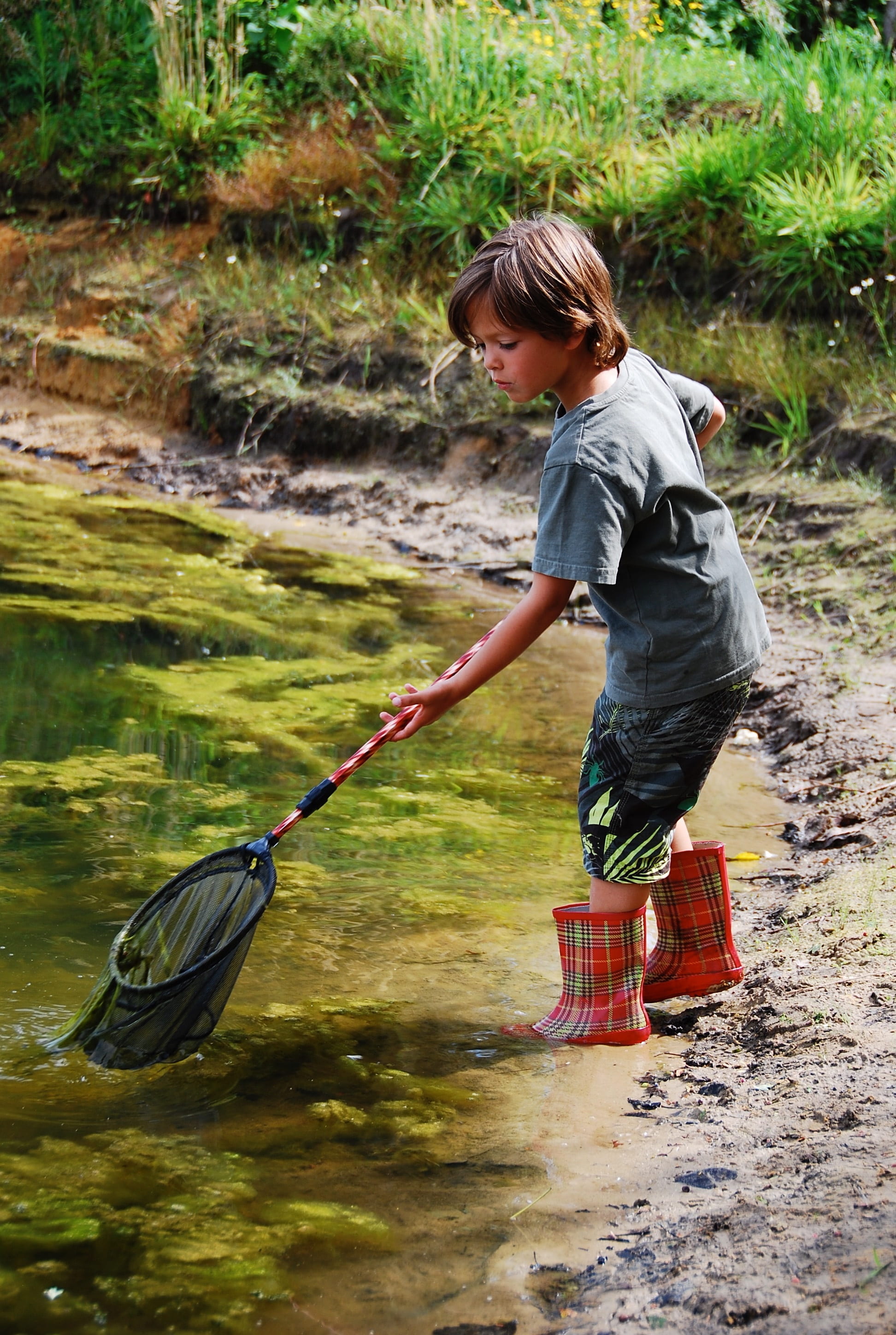 boots, child, hairstyle, leisure activity, landing net, green, nature, standing, real people, people, innocence, grass, river, youth, cute, enjoyable, one person, Phone HD Wallpaper