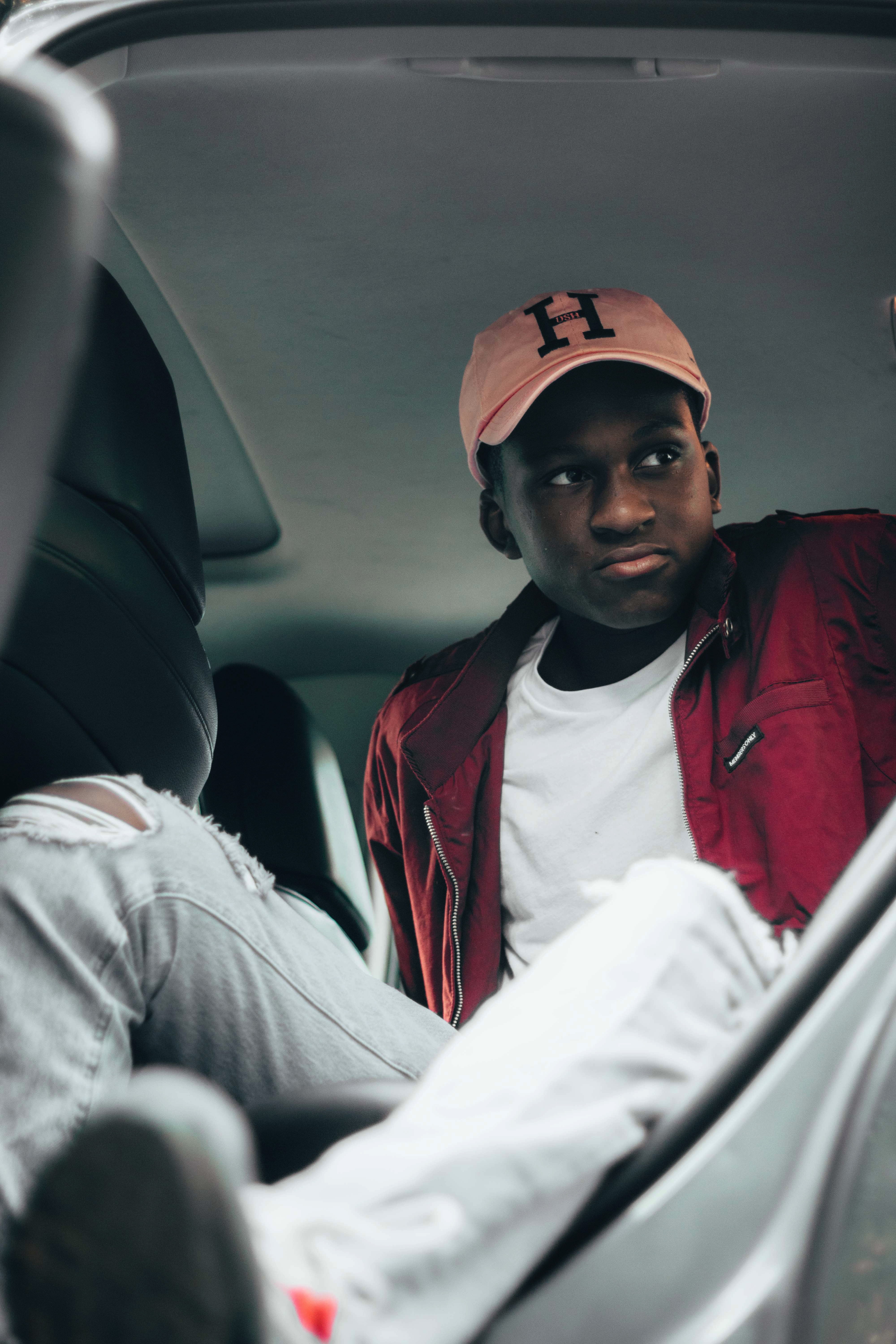 motor vehicle, wearing, car, baseball cap, belt, vehicle interior, undershirt, man, vehicle, clothing, indoors, land vehicle, red, front view, two people, Phone HD Wallpaper