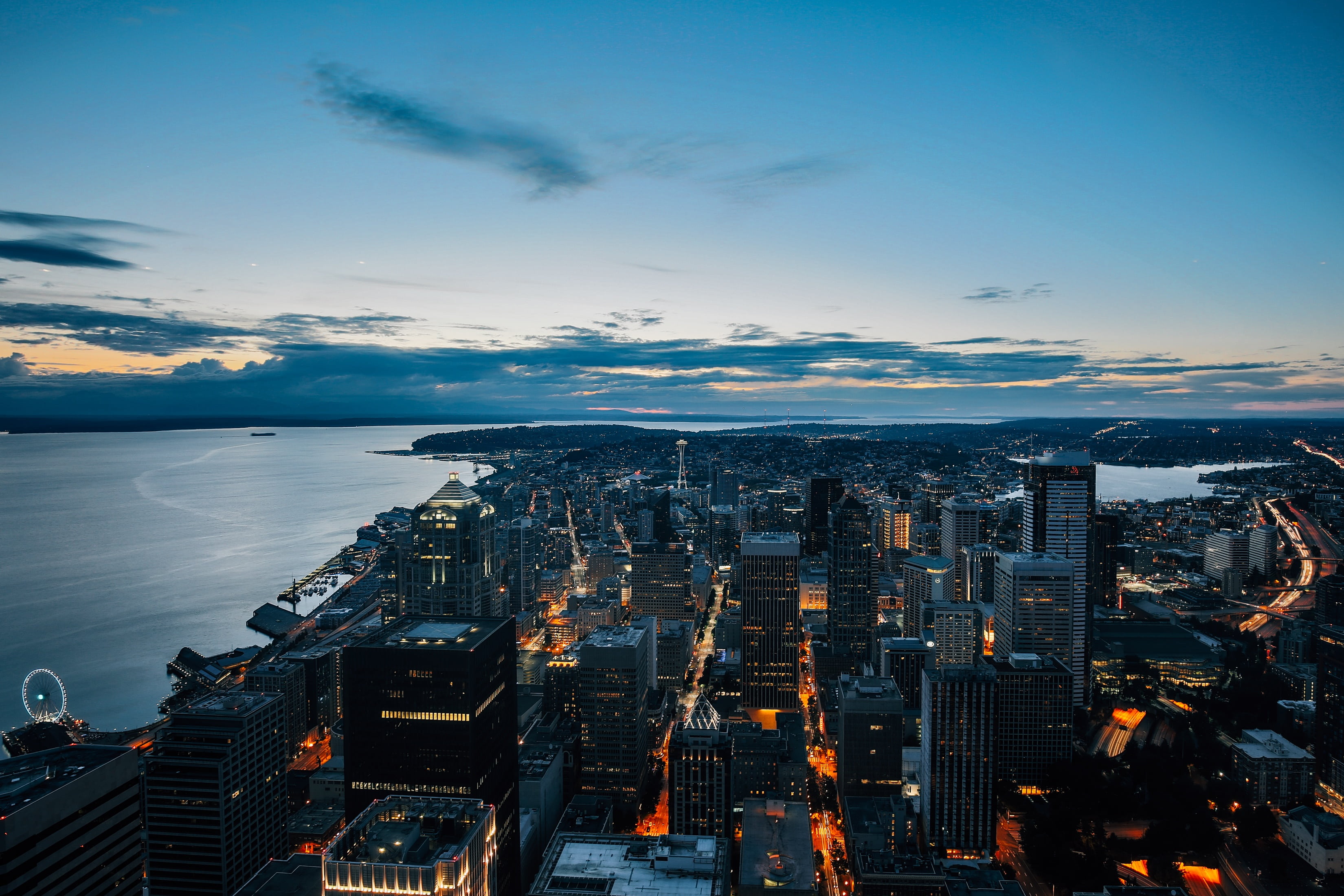modern, blue, lighted, 2K, sea, clouds, no people, architecture, illuminated, office, view, skyscraper, sunset, cloud - sky, cityscape, building exterior, HD Wallpaper