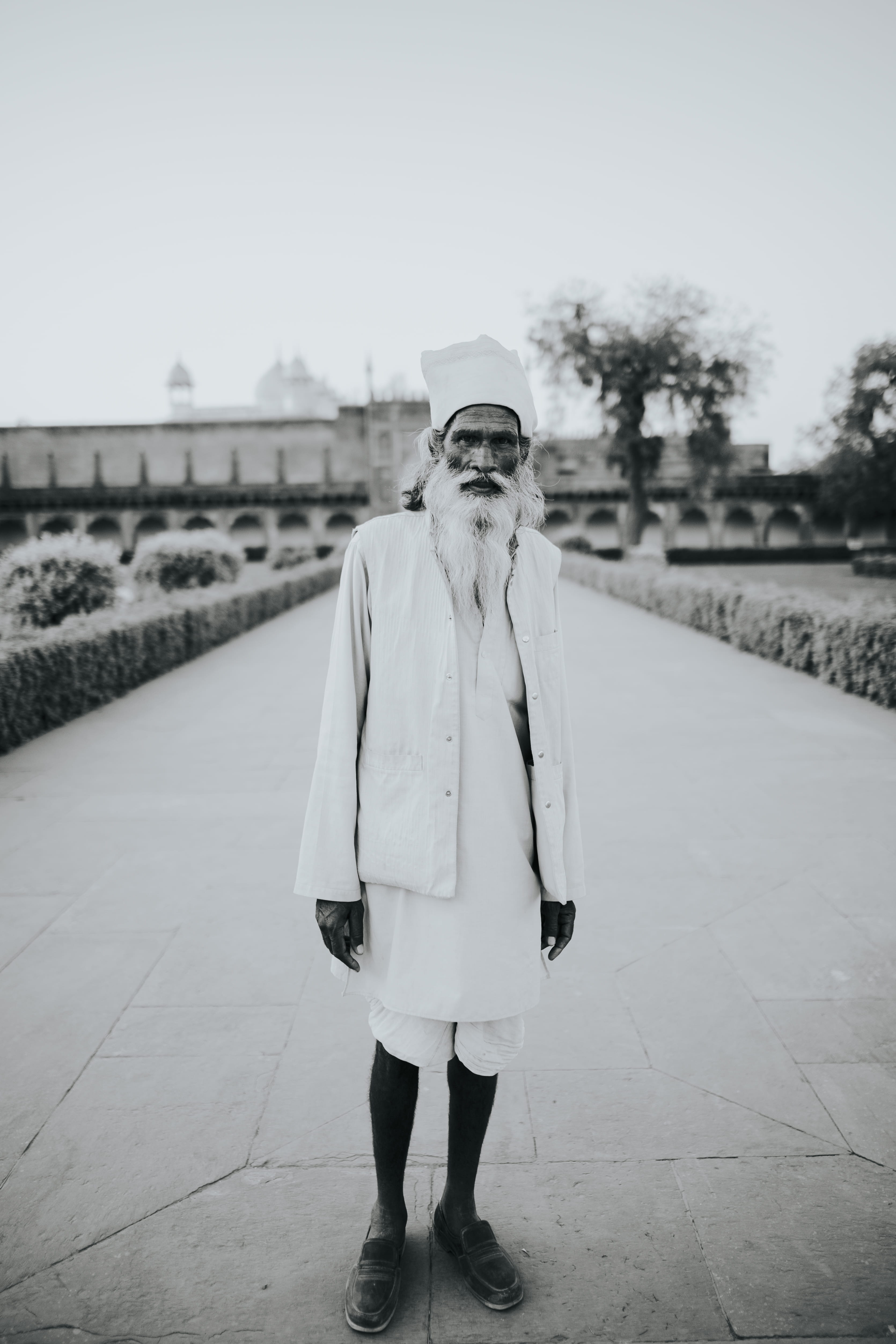 lifestyles, outdoors, street, indian man, culture, stand, pathway, grayscale, old man, outdoos, looking at camera, young adult, portrait, leisure activity, Phone HD Wallpaper