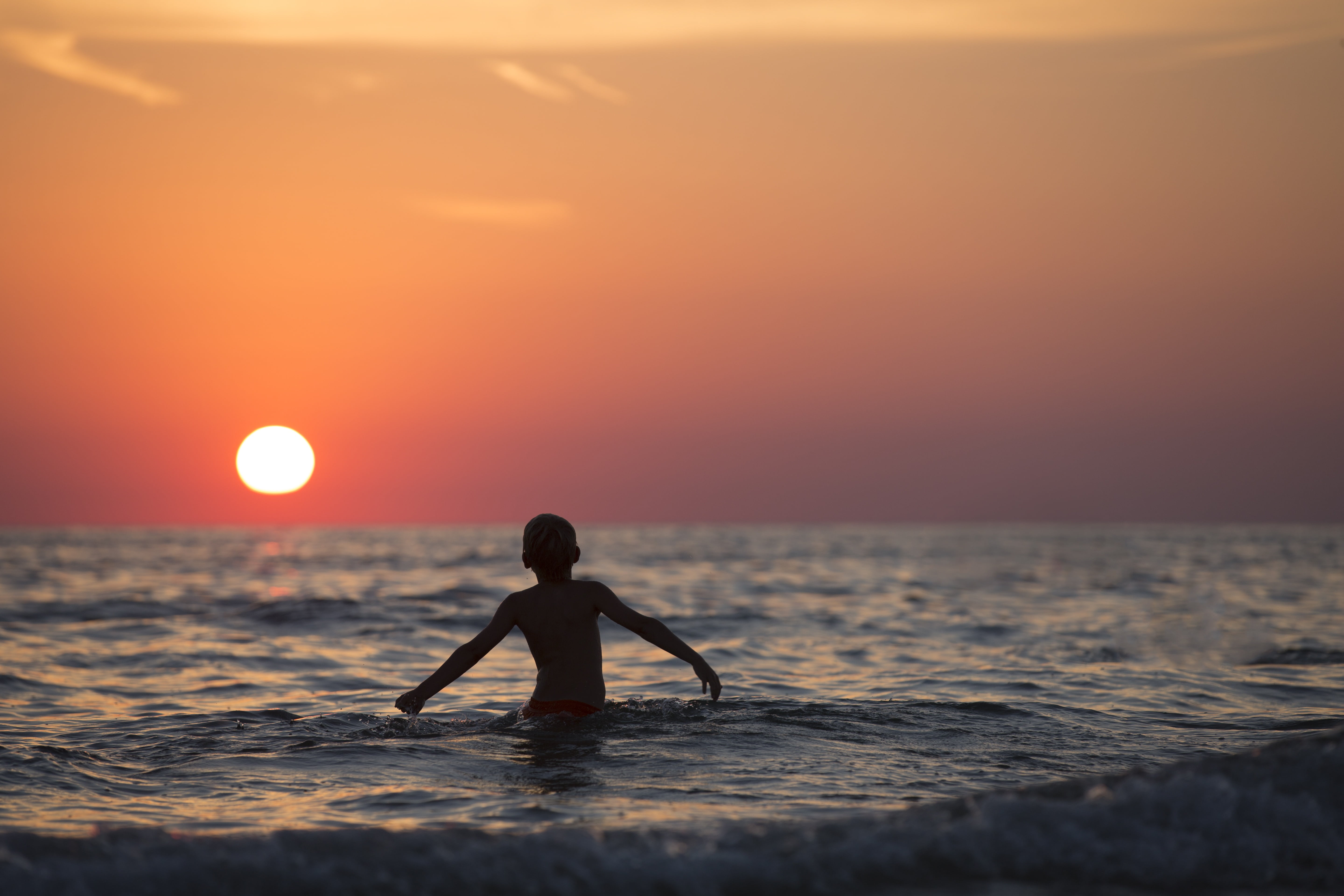 waves, recreation, water, boy, outdoors, horizon over water, beach, body, person, leisure activity, sunlight, beauty in nature, silhouette, one person, HD Wallpaper