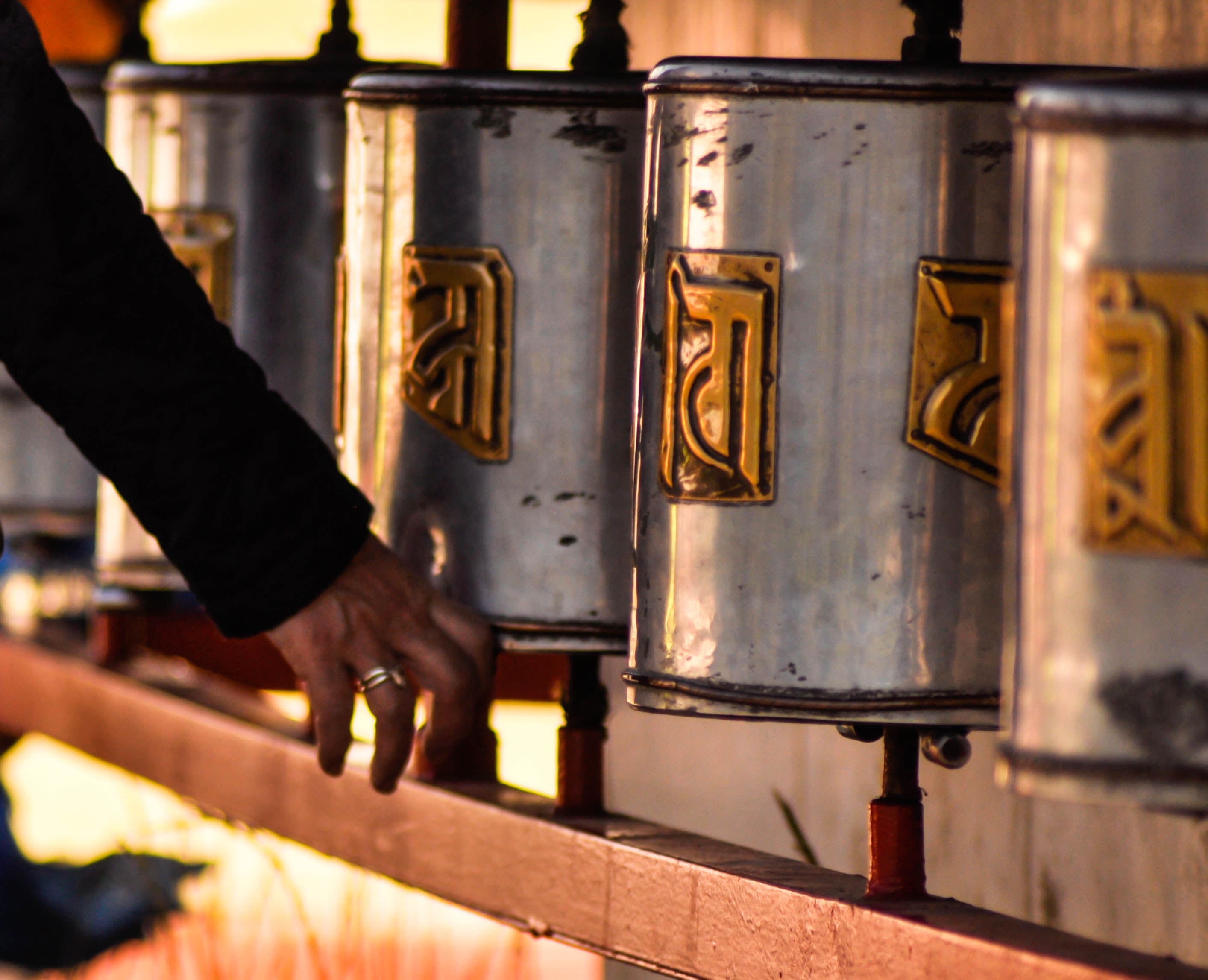 occupation, prayer, hand, tibetan, body part, temple, prayer wheels, real people, working, men, buddhist, religion, steering, fire, monastery, 2K, focus on foreground, HD Wallpaper