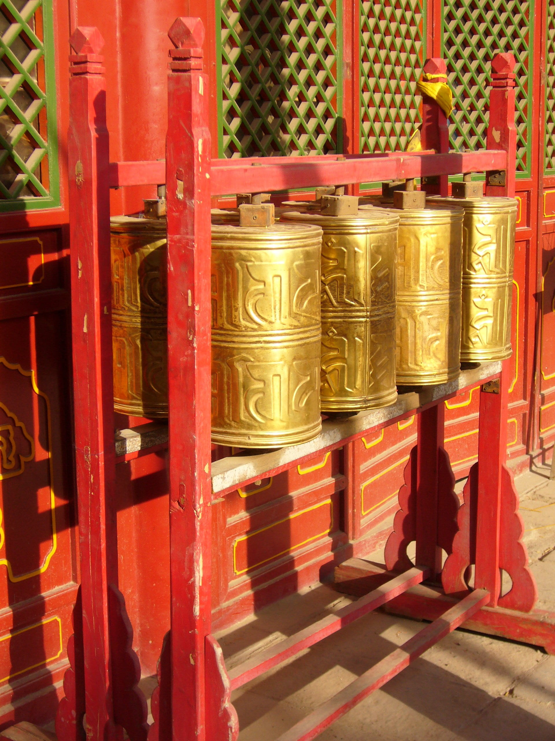 indoors, stand, colored, tibet, architecture, red, 2K, no people, monastery, sunlight, wood - material, religion, place of worship, china, metal, prayer, Phone HD Wallpaper