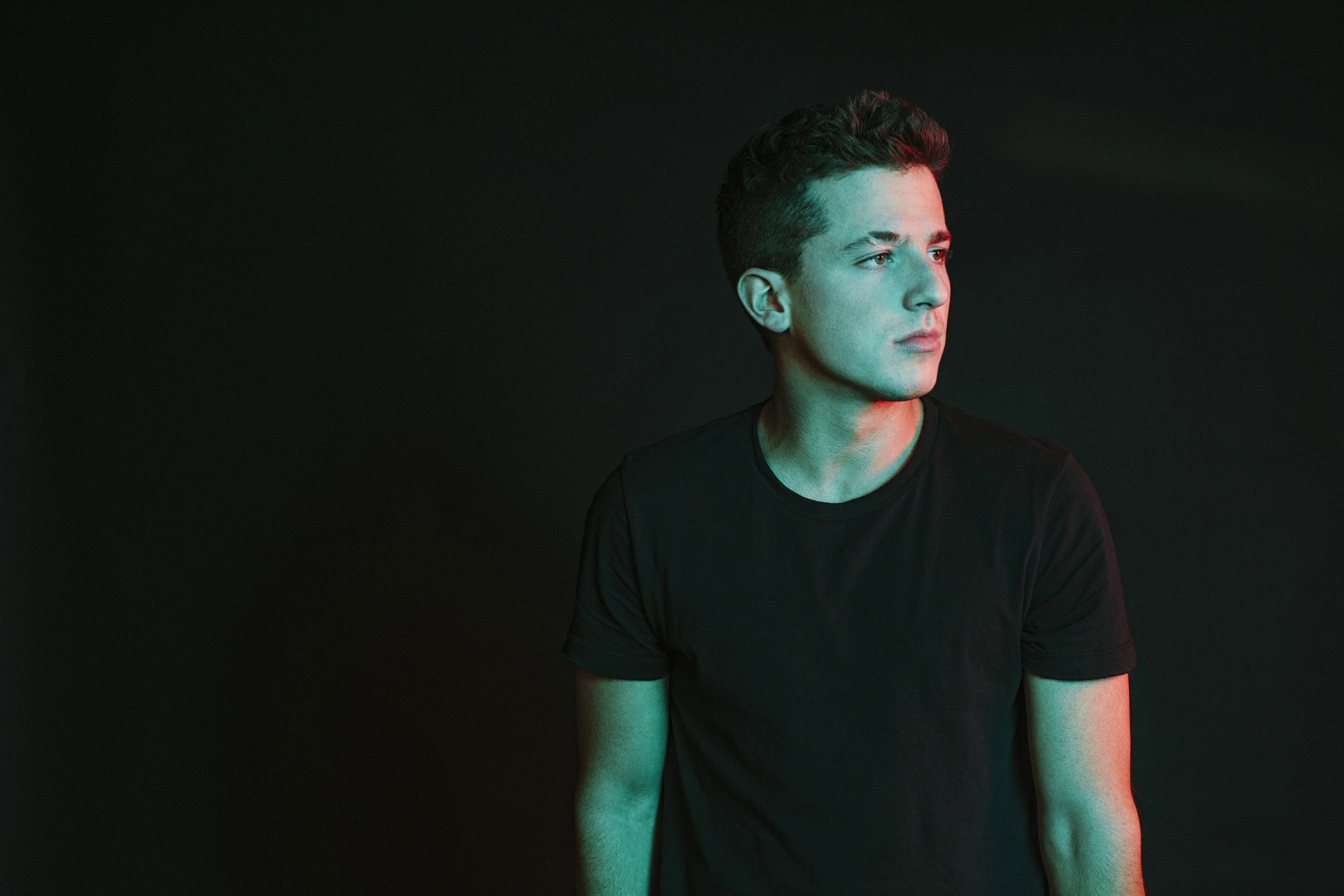 looking, standing, 4K, young men, front view, contemplation, portrait, young adult, casual clothing, cut out, black, copy space, charlie, one person, black background, HD Wallpaper