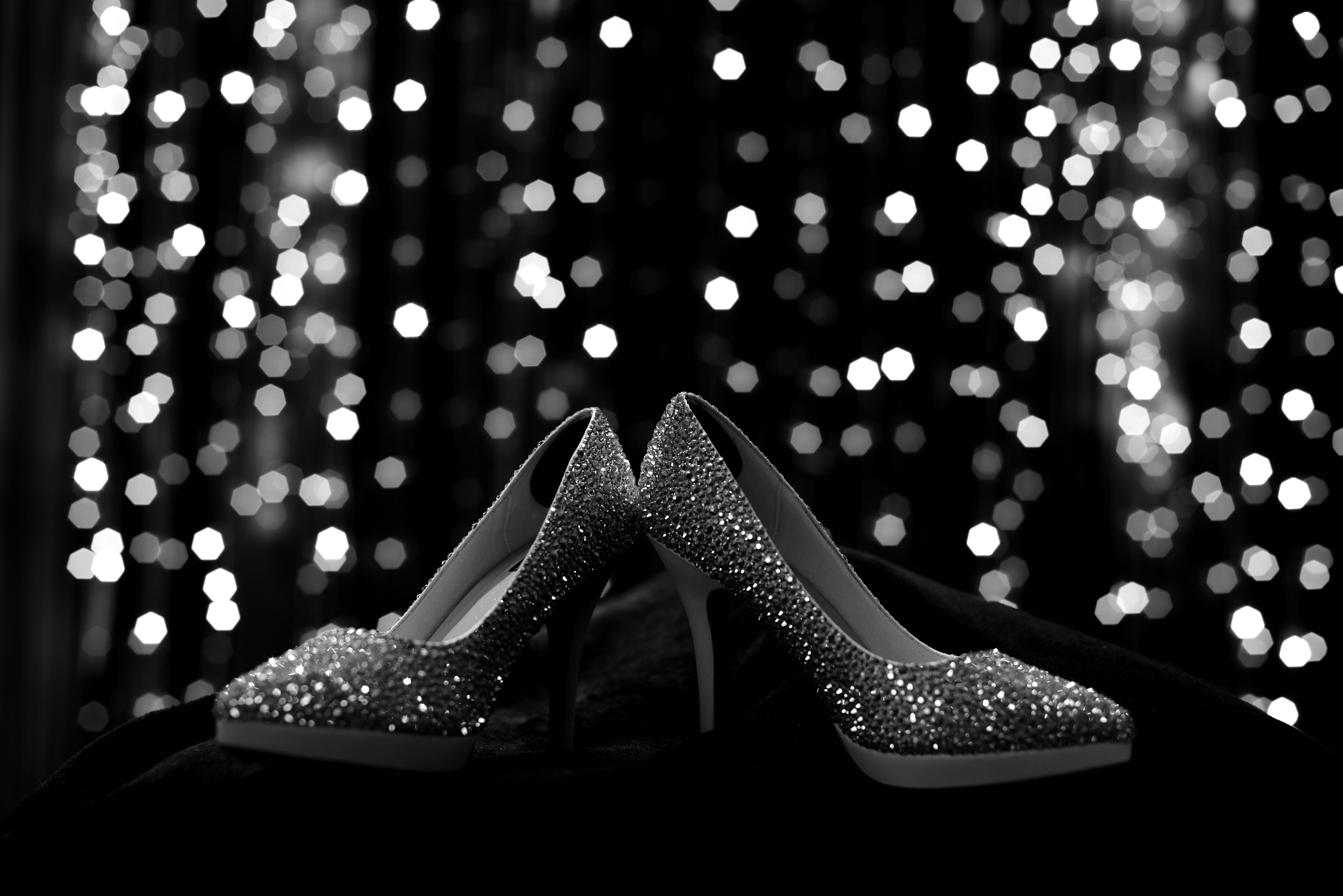 fashion, focus on foreground, shiny, one person, celebration, illuminated, close-up, 5K, stiletto, shoe, christmas lights, human leg, bokeh, black and white, HD Wallpaper