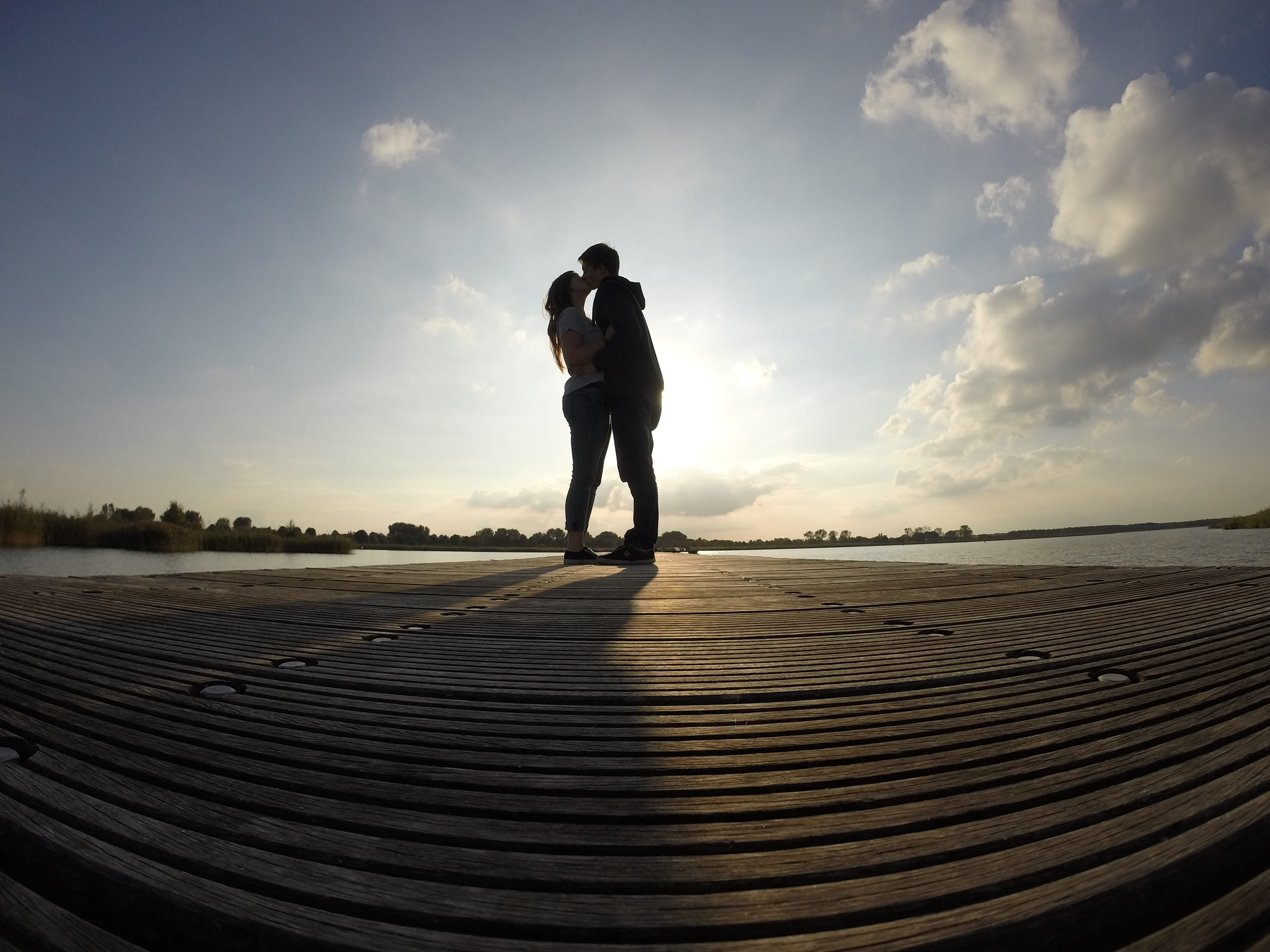 day, fish, water, setting sun, sea, beach, sky, two people, wooden bridge, waters, nature, real people, women, kissing, leisure activity, people, couple - relationship, HD Wallpaper