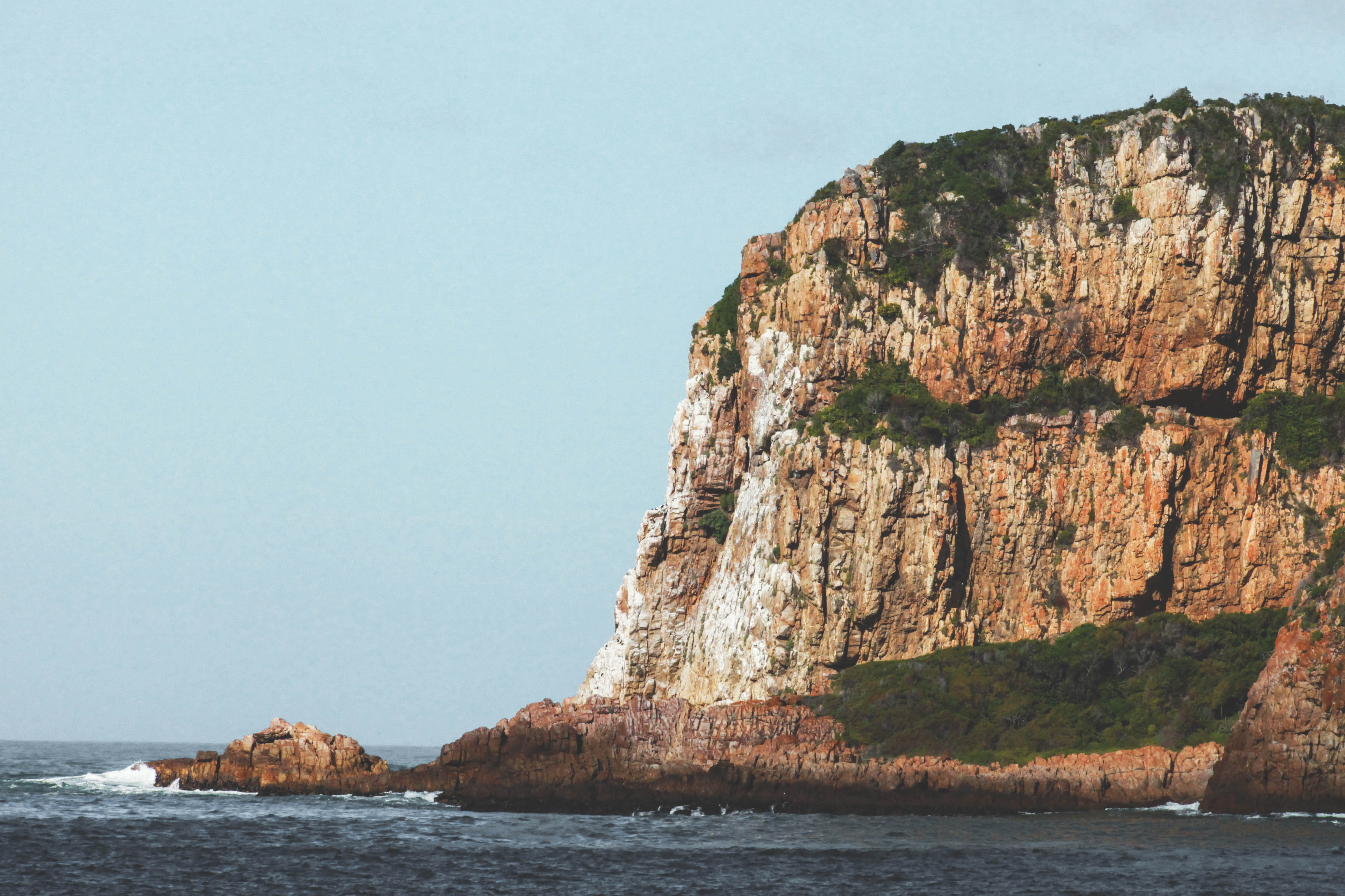 clear sky, solid, cliff, grass, rock formation, beauty in nature, water, rock, formation, south africa, nature, day, rocky coastline, no people, sky, ocean, HD Wallpaper