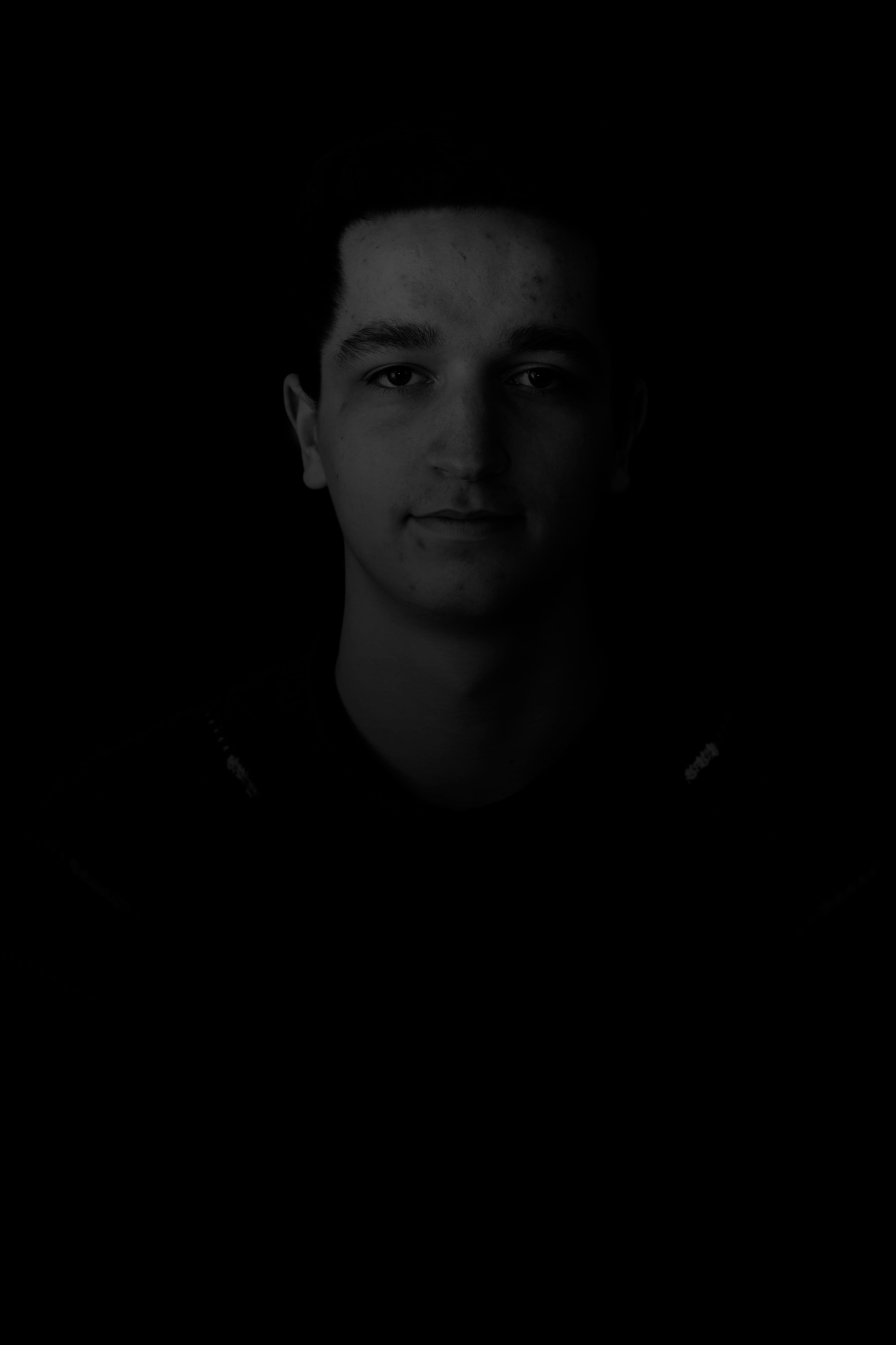 studio shot, black background, black, dark, portrait, young adult, men, head, human, photography, headshot, face, indoors, photo, one person, happy, lowkey, Phone HD Wallpaper