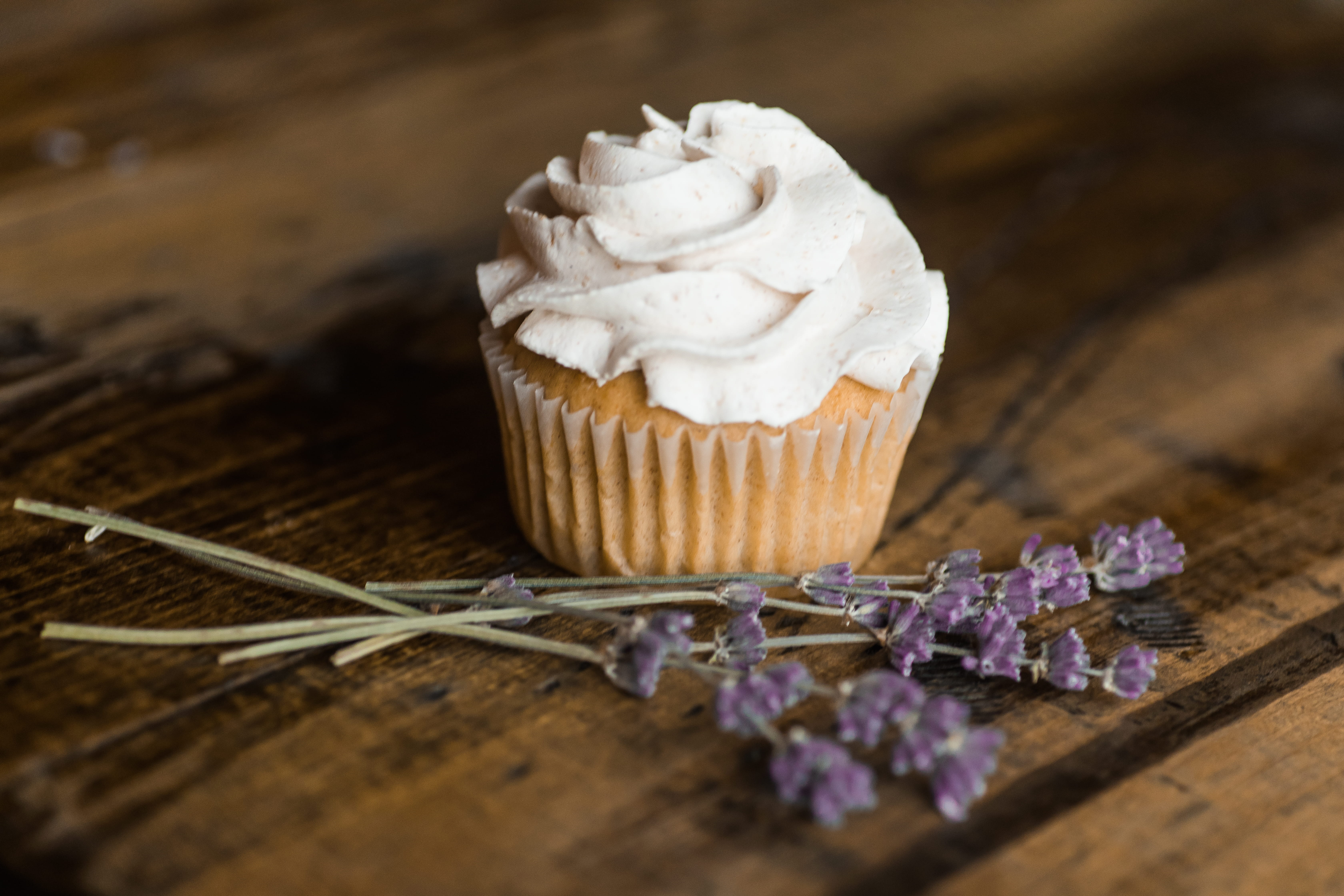 blur, indoors, treat, table, bokeh, lavender, sweets, cupcake, minimal, selective focus, focus on foreground, cupcake holder, no people, sweet food, cream, HD Wallpaper