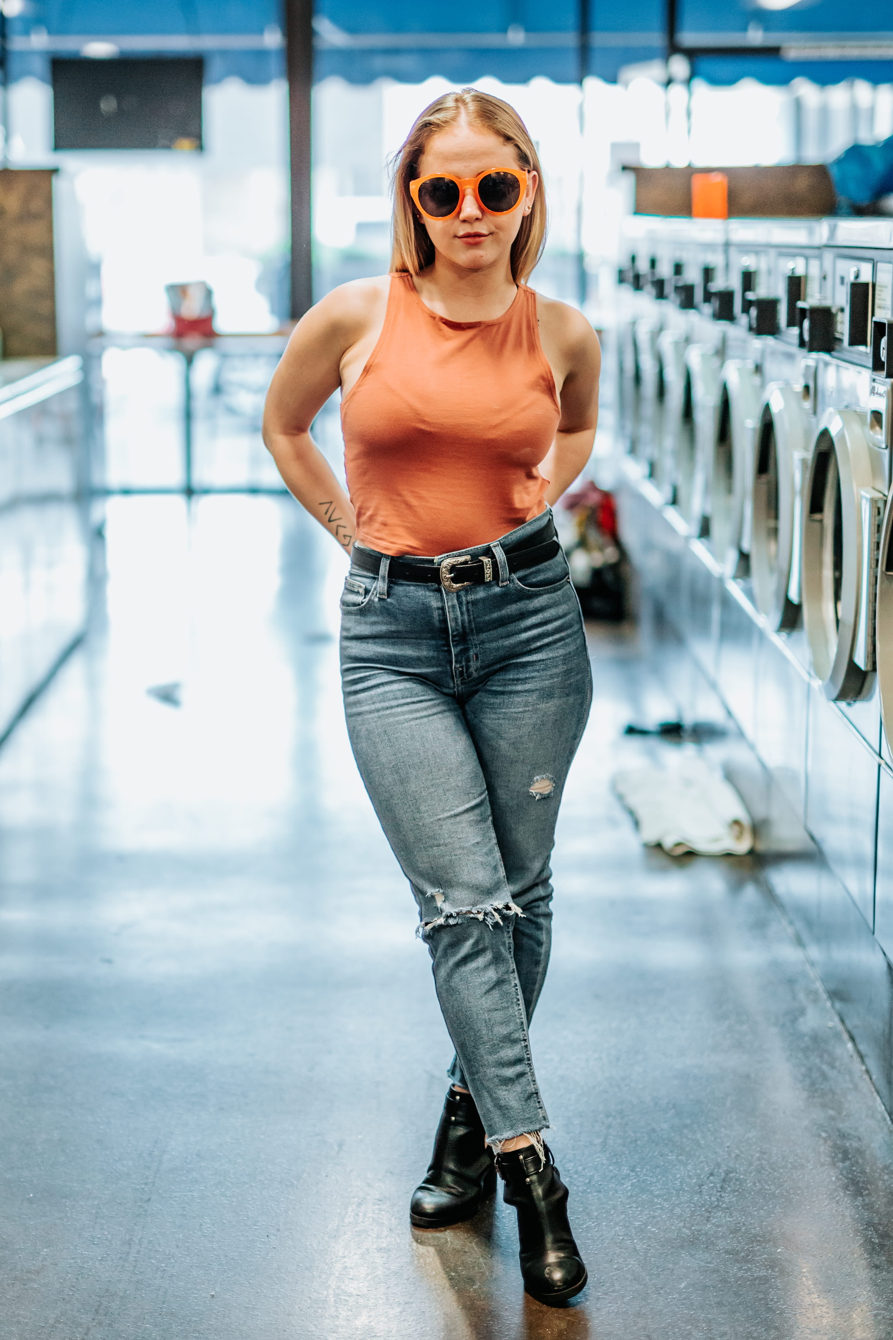 laundry mat, person, jeans, lifestyles, top, portrait, standing, orange, adult, full length, wearing, load, appliances, hairstyle, young, indoor, leisure activity, Phone HD Wallpaper