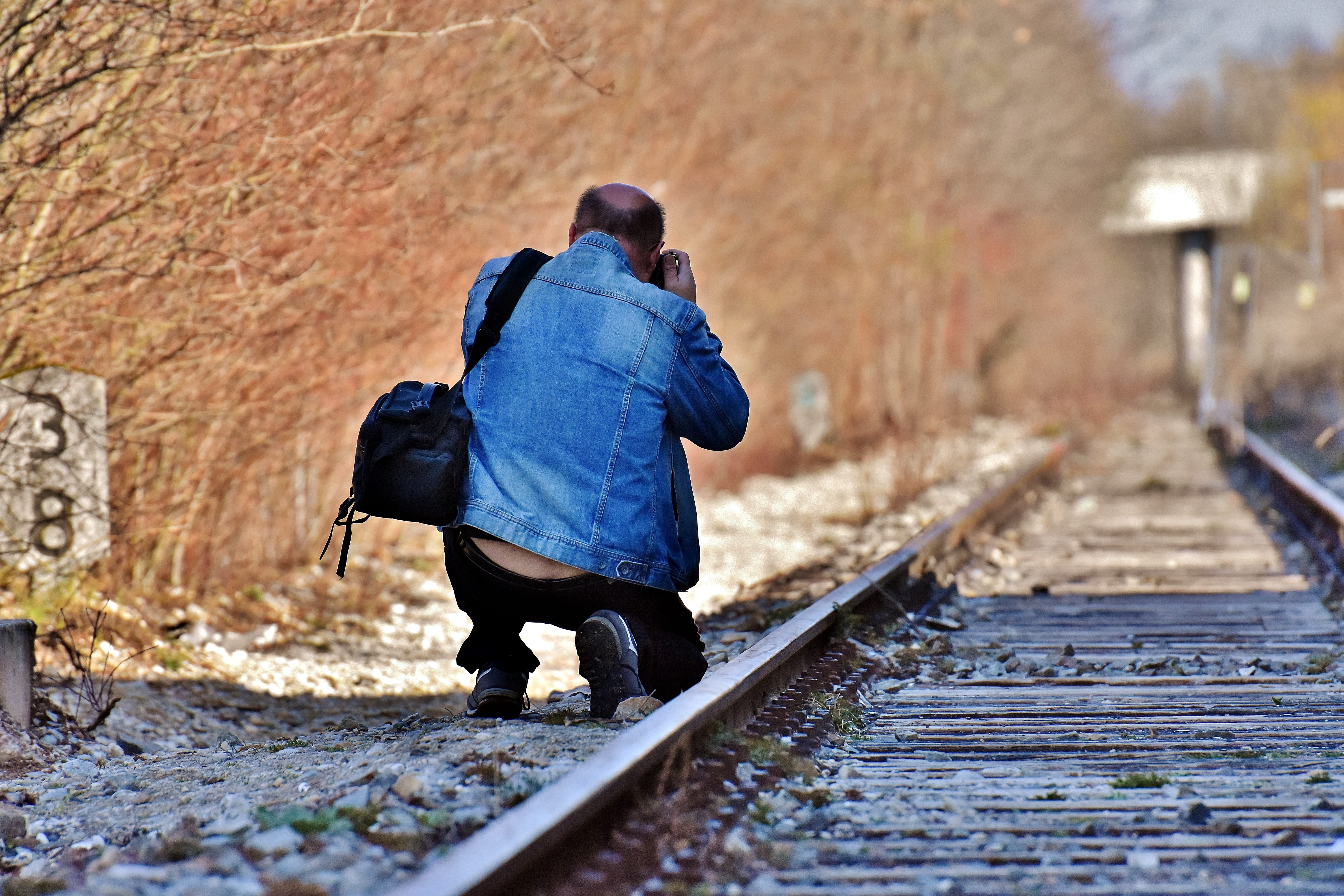 men, travel, 5K, railroad tracks, seemed, holding, walking, outdoors, old railroad tracks, daytime, rail transportation, track, mode of transportation, HD Wallpaper