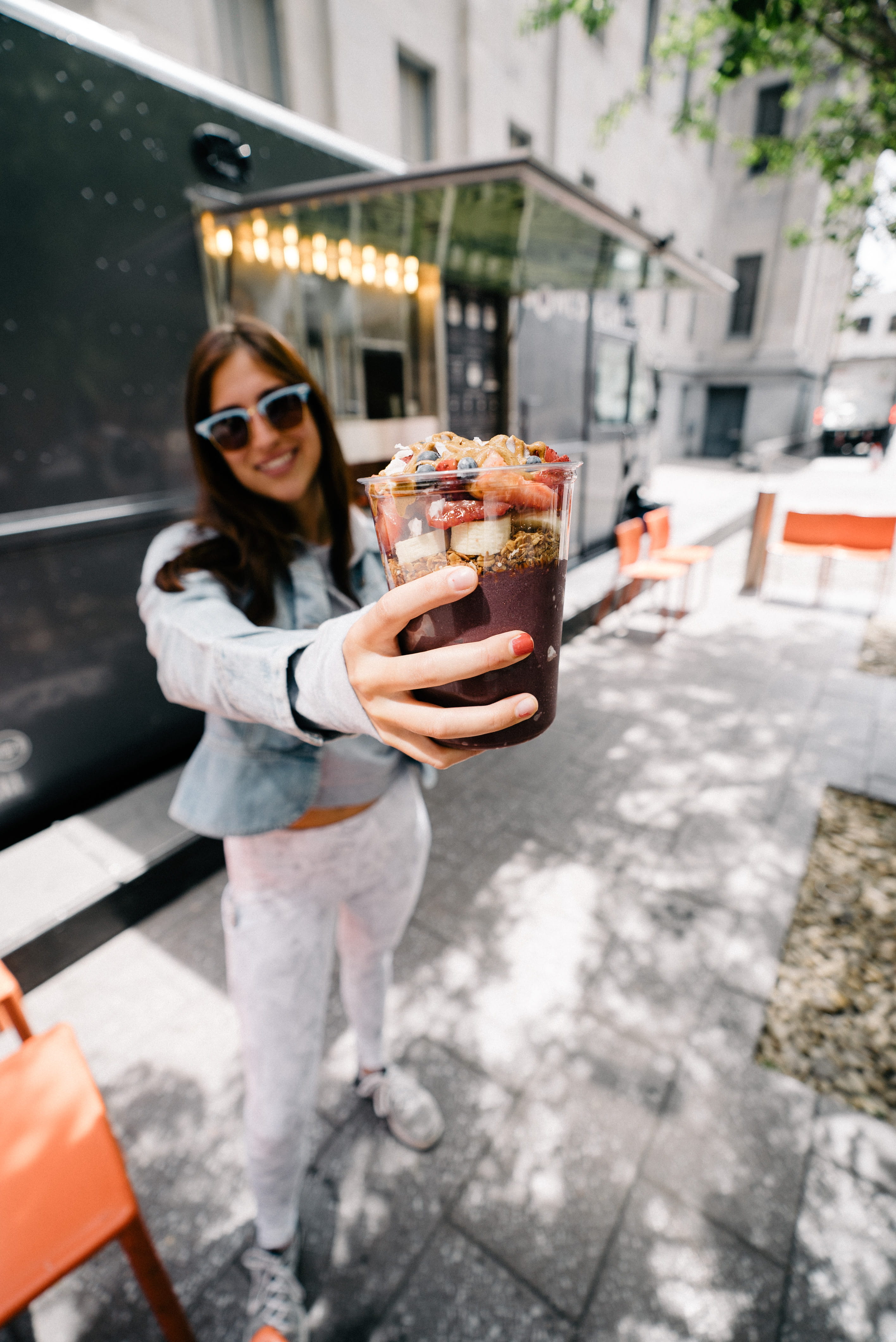 shoe, standing, footwear, clothing, holding, dessert, human, woman, chocolate, shake, city, young adult, food and drink, tarmac, restaurant, smiling, outdoors, Phone HD Wallpaper