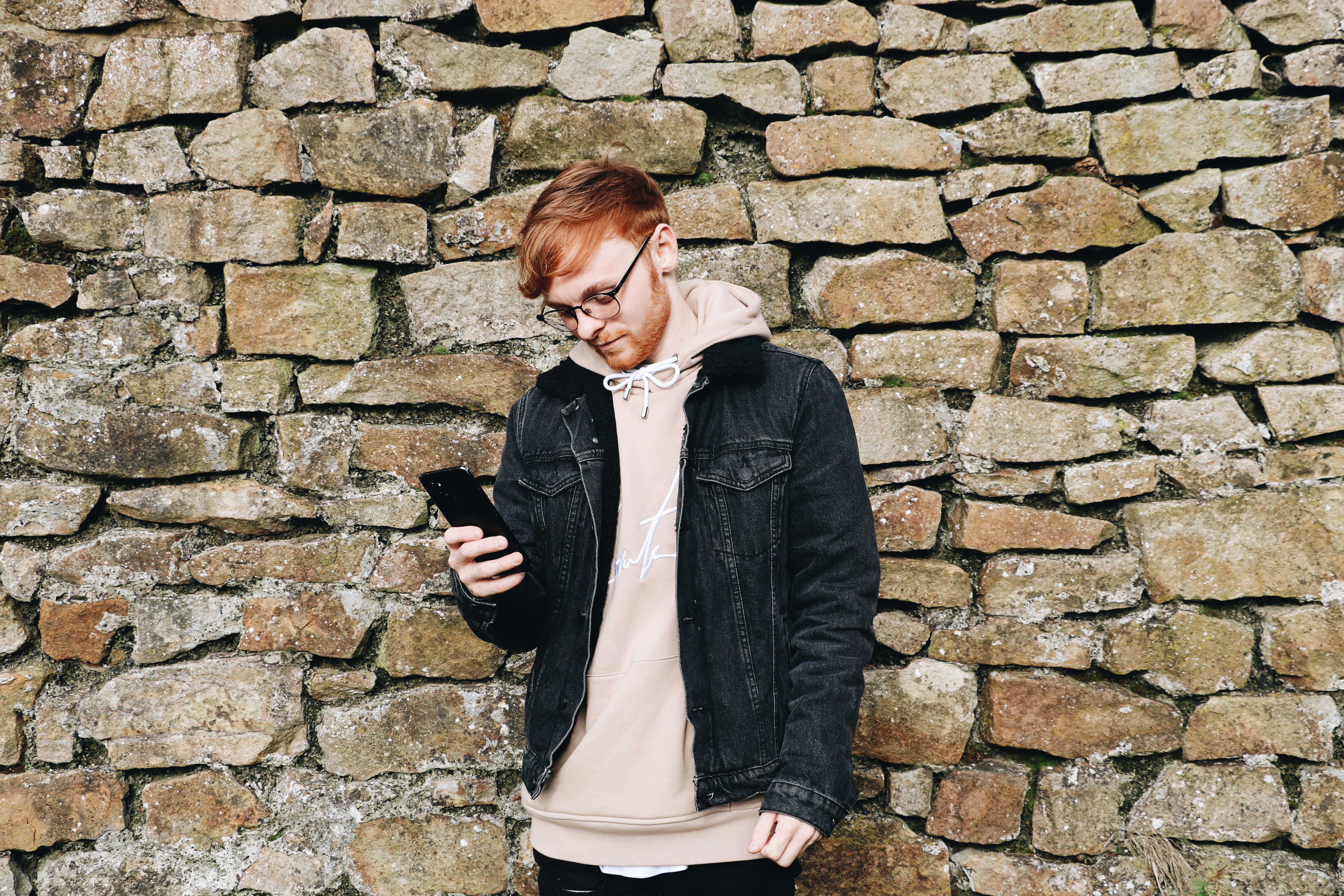 holding, outdoors, person, stone wall, smartphone, wall - building feature, footwear, photo, human, pavement, hairstyle, front view, standing, brick, path, HD Wallpaper