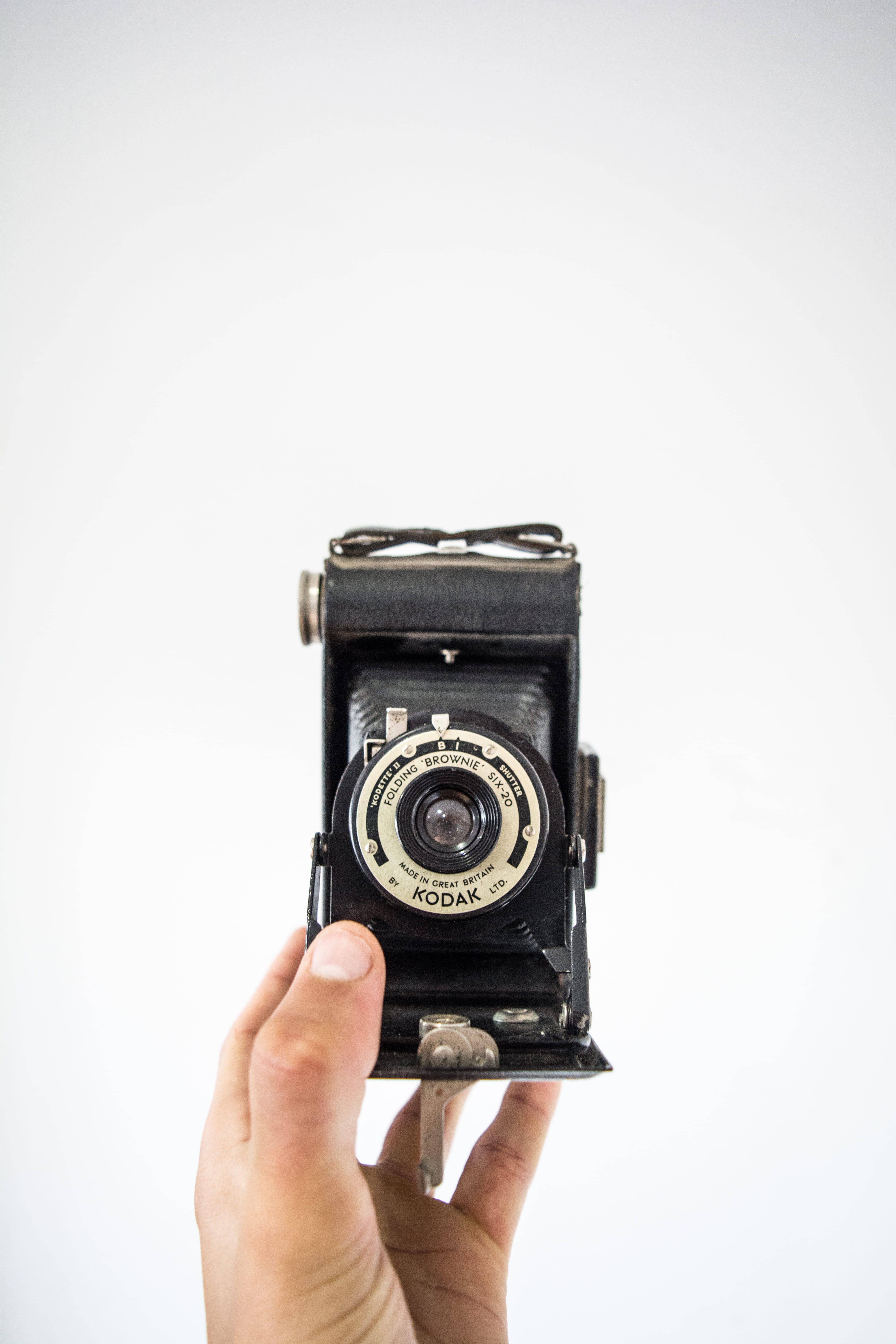 indoors, film, close-up, kodette, black, hand, old, camera, photographer, shutter, antique, 5K, land, single object, photography themes, vintage, person, Phone HD Wallpaper