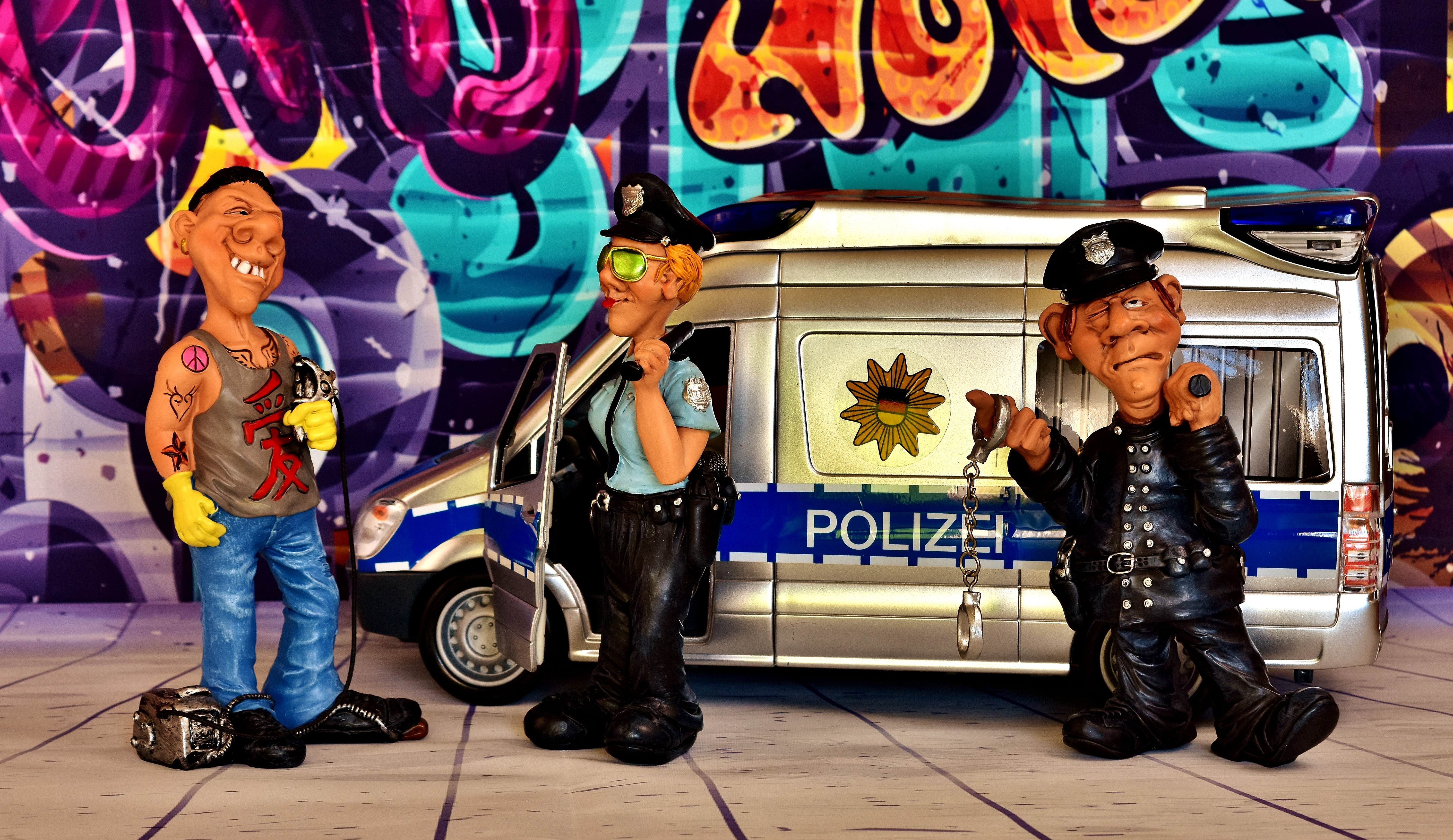 damage to property, three, adult, sitting, people, text, colorful, male likeness, representation, spray, figurines, mammal, police officers, full length, HD Wallpaper