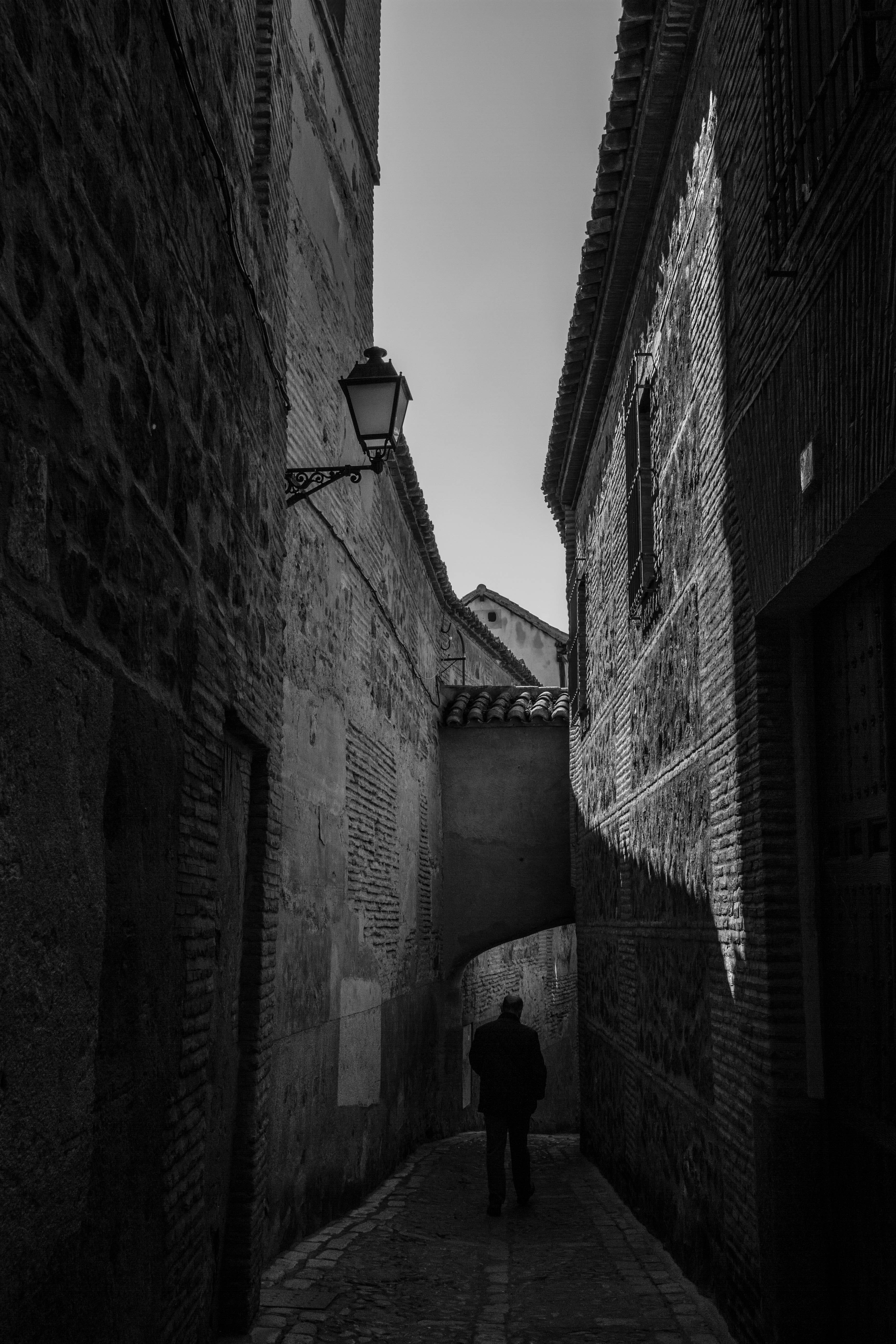 narrow, day, village, built structure, one person, the way forward, city, direction, street, building exterior, toledo, dark, blackandwhite, town, man, Phone HD Wallpaper
