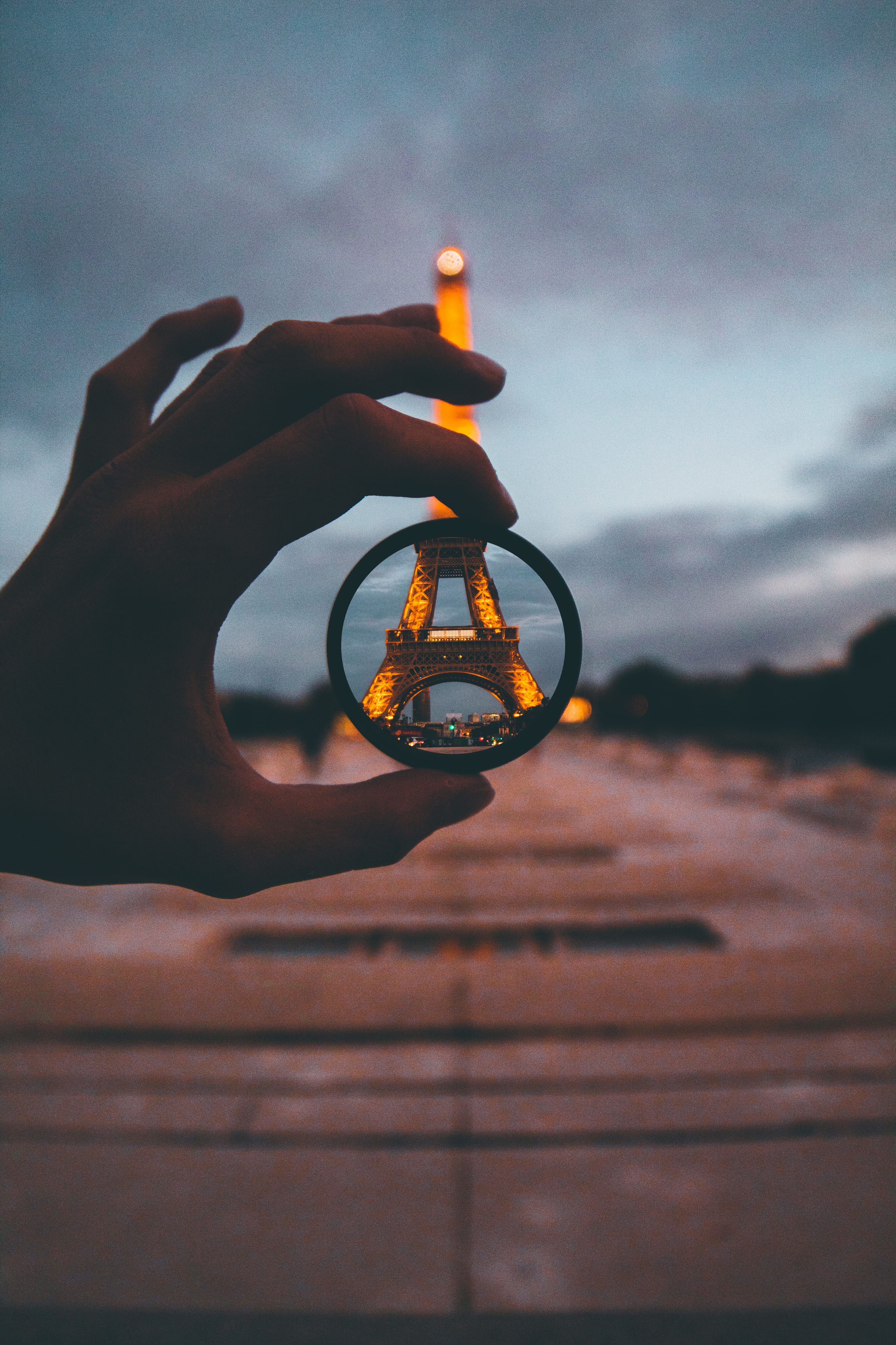 lens, urban, real people, paris, moody, holding, eiffel, anywhere, cloud - sky, one person, view, bangle, focus, selective, close-up, eiffel tower, circular, Phone HD Wallpaper