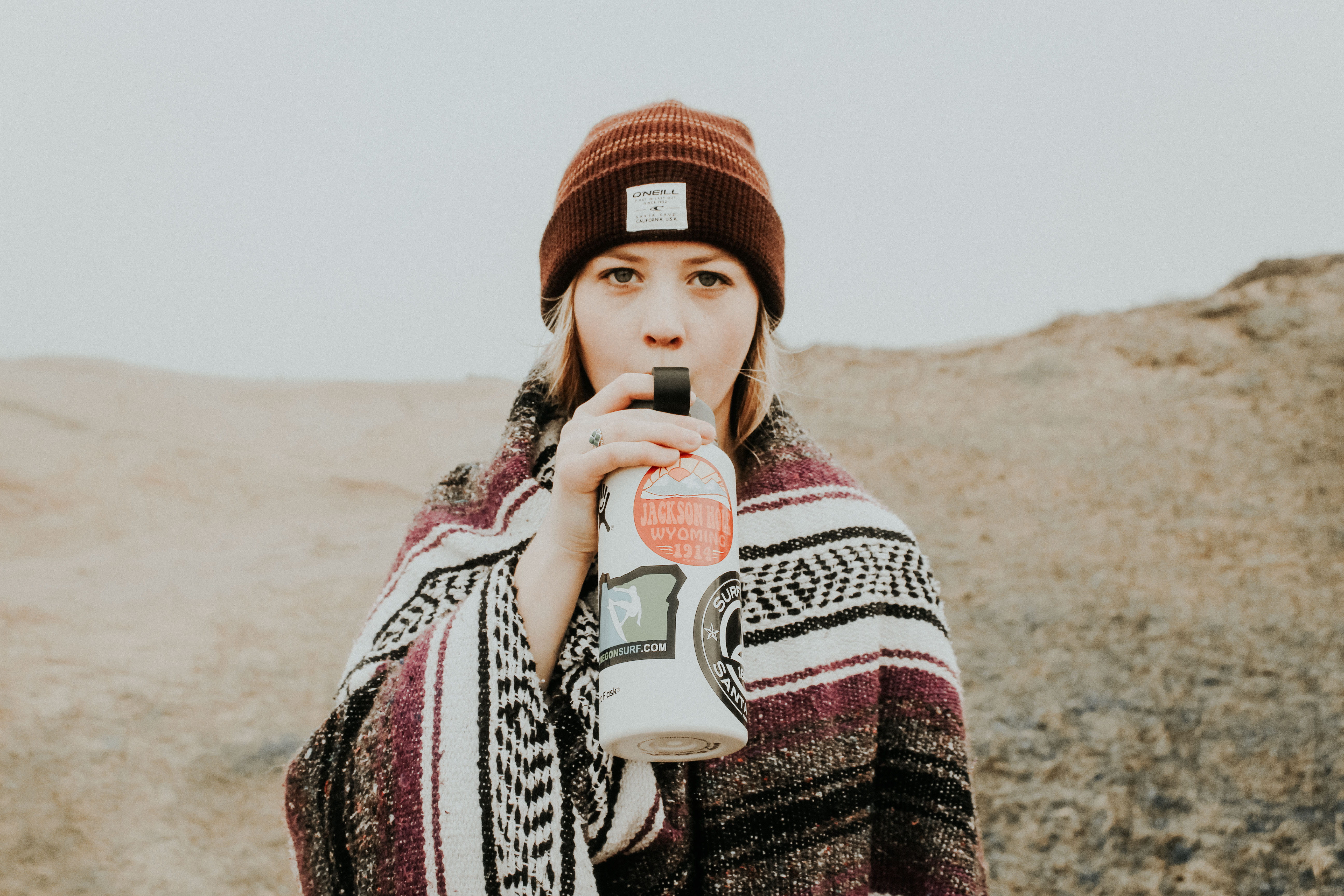 standing, 5K, water bottle, winter, hat, young adult, front view, looking at camera, leisure activity, contemplation, holding, tumbler, beanie, waist up, HD Wallpaper