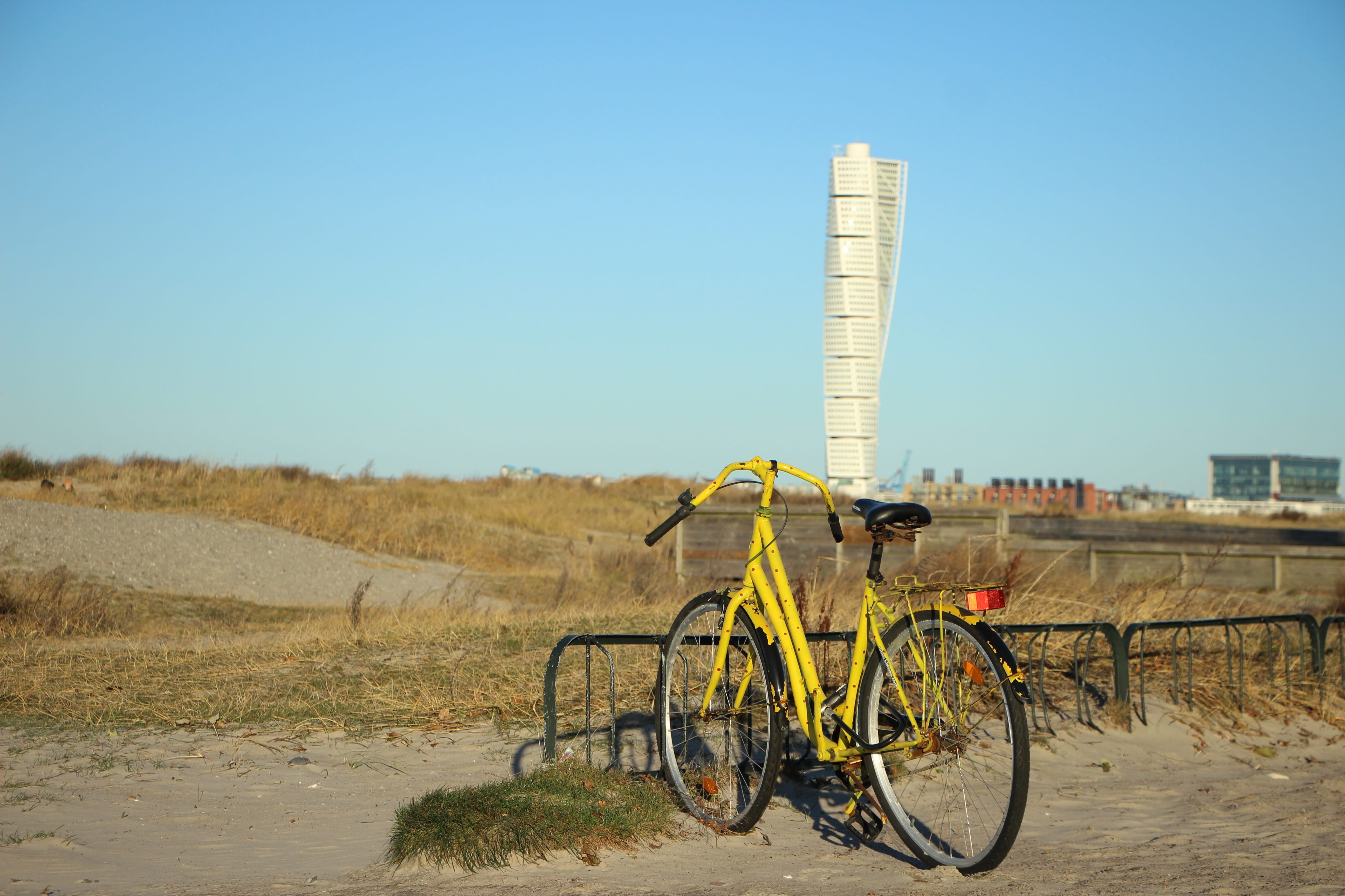 5K, building exterior, bike racks, sunny, land vehicle, no people, yellow, beach, land, clear sky, built structure, malmö, architecture, nature, sky, copy space, HD Wallpaper